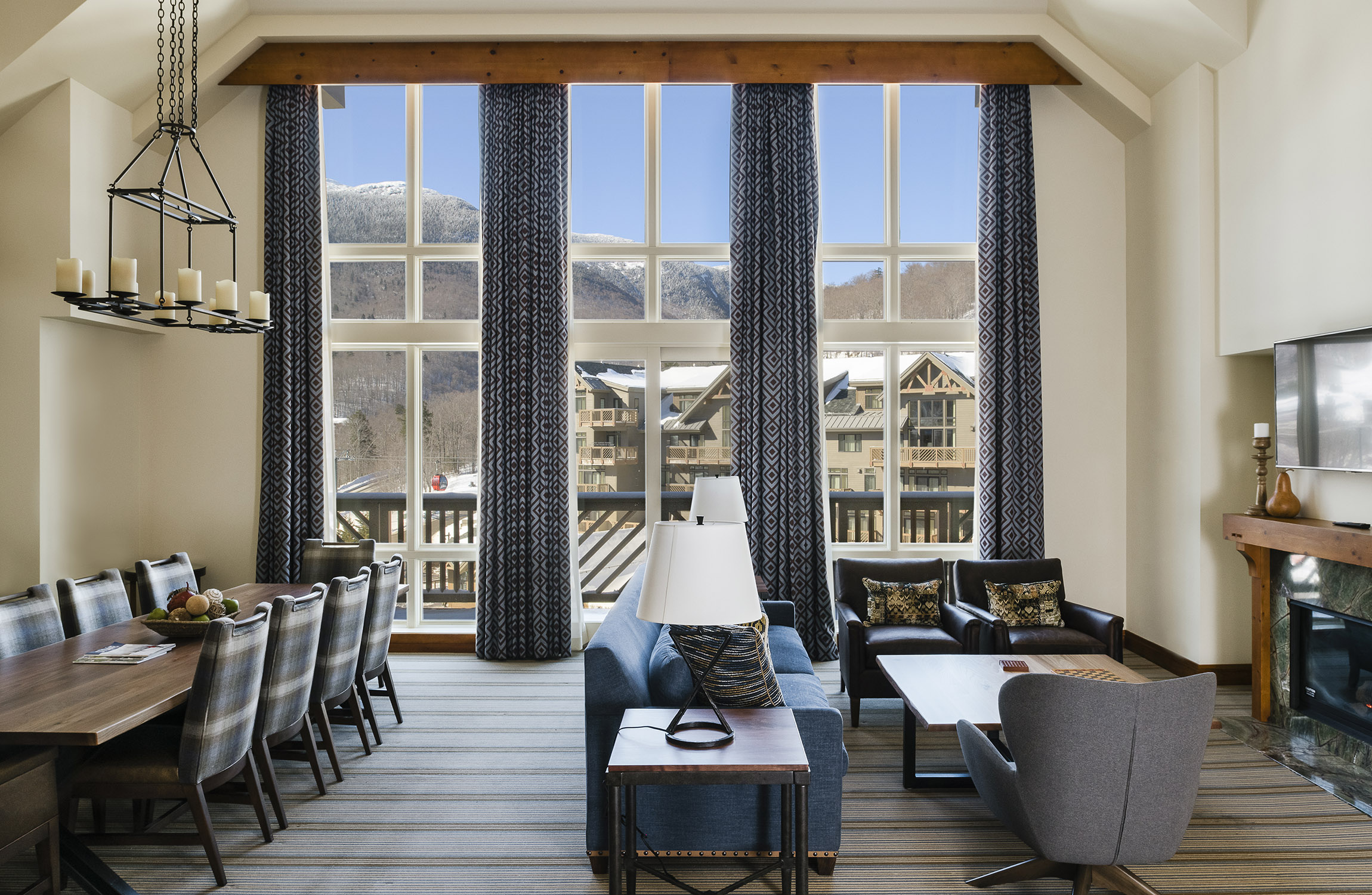 Penthouse living and dining lounge with mountain views, The Lodge at Spruce Peak, Stowe, USA