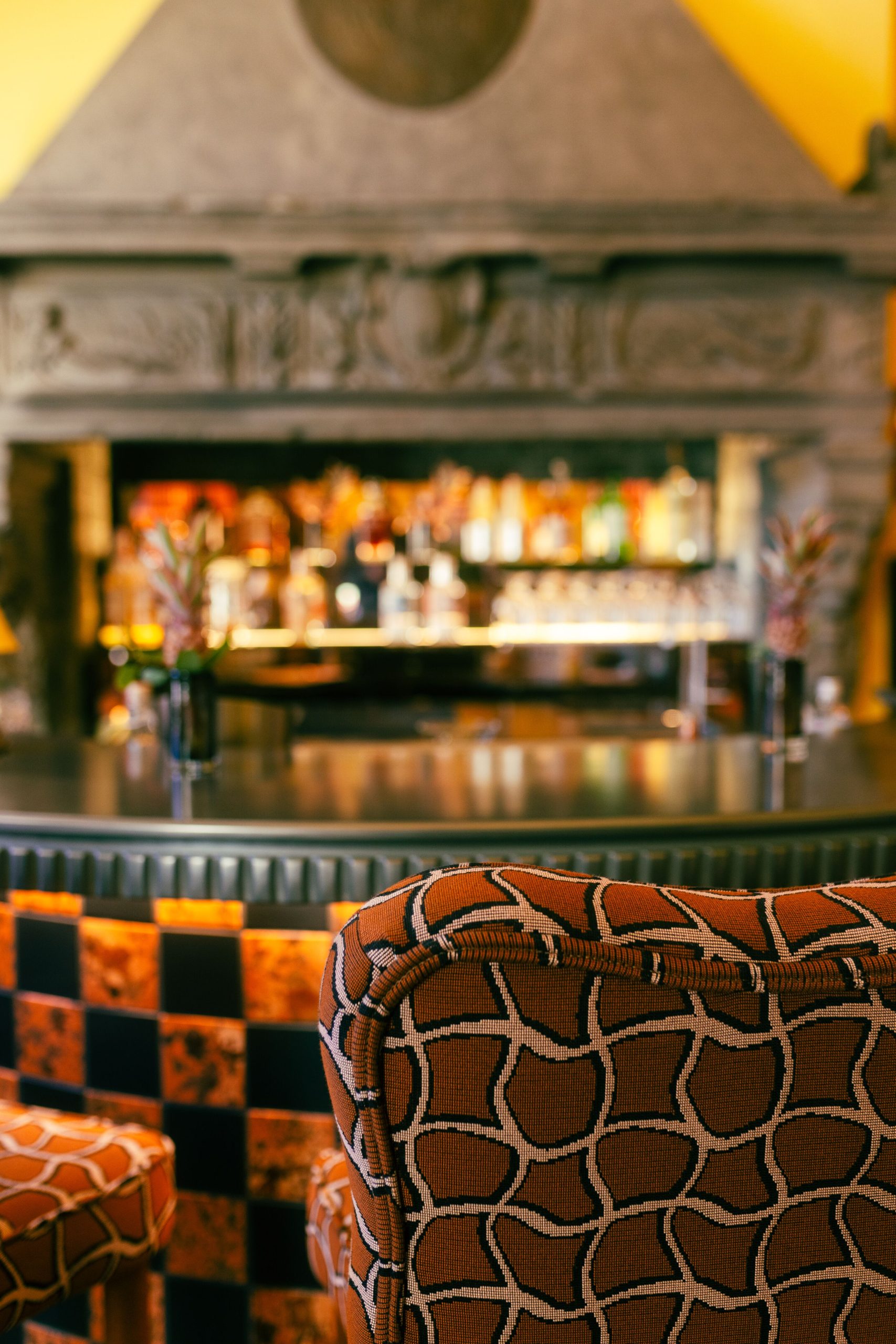 Patterned armchairs beside a softly lit bar, Kulm Hotel St. Moritz, St. Moritz, Switzerland