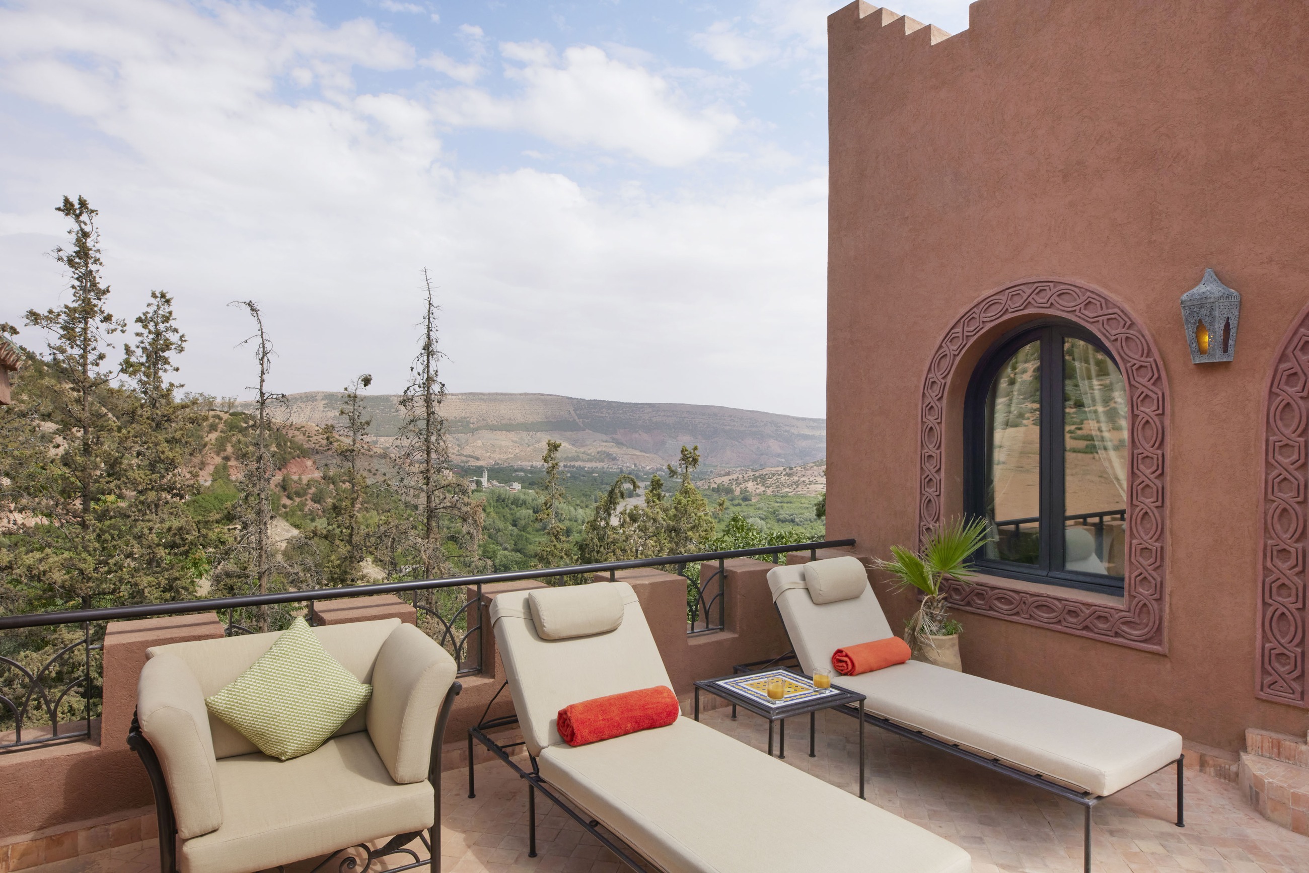 Suite balcony with seating overlooking the mountain valley at Kasbah Tamadot, Atlas Mountains, Morocco