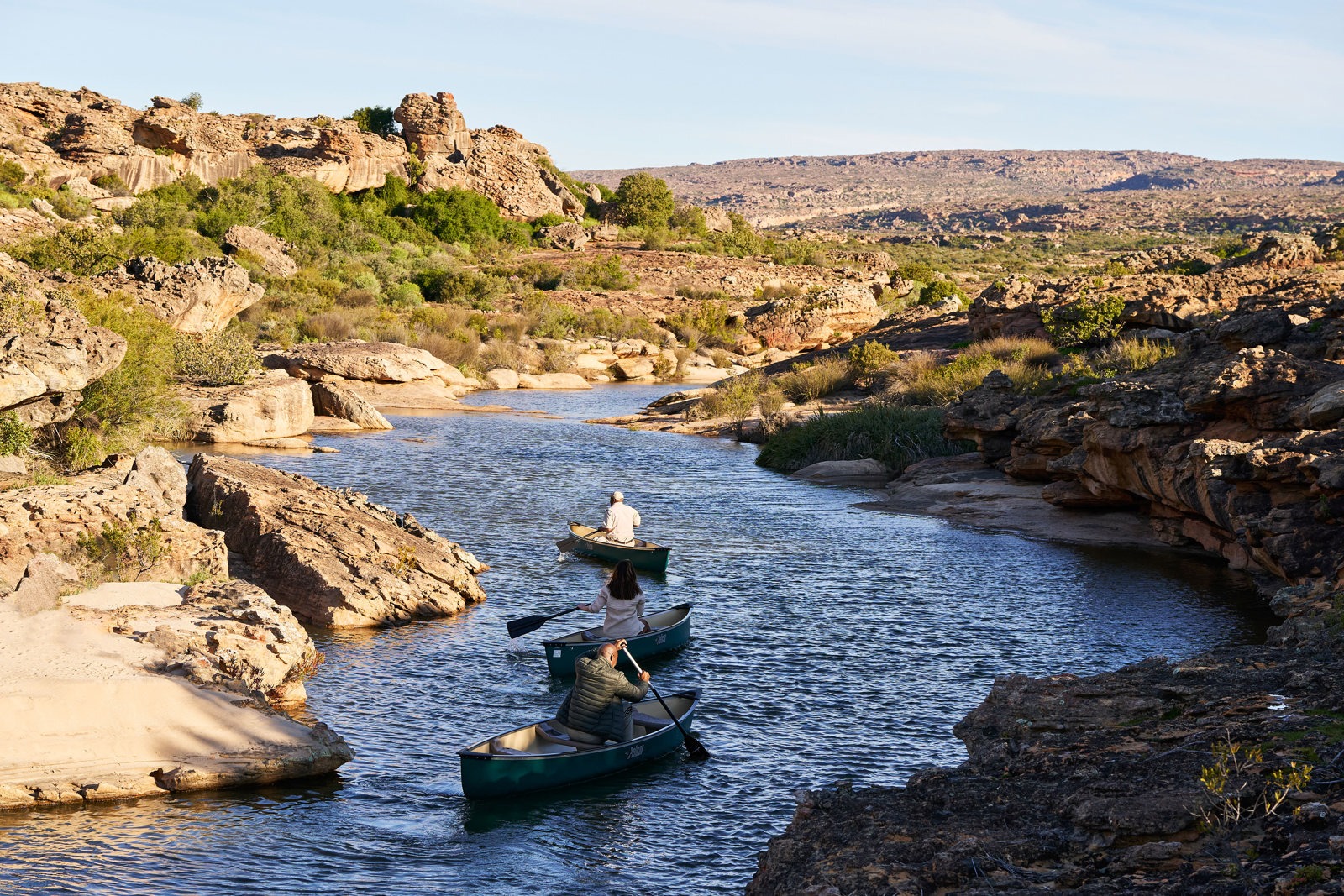 Canoeing along a rocky river channel, Bushmans Kloof, Cederberg Mountains, Western Cape, South Africa