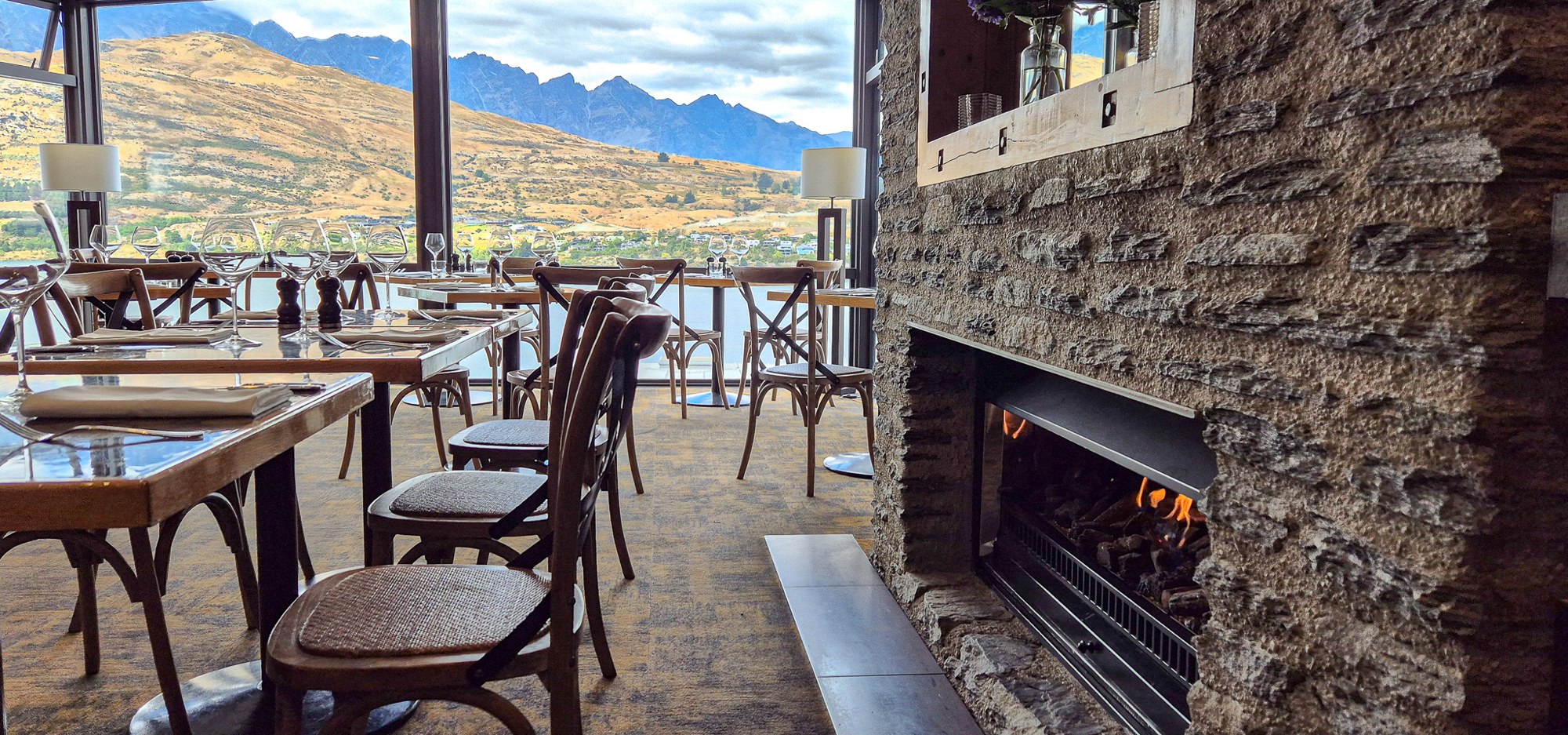True South dining room and fireplace overlooking Lake Wakatipu at The Rees Hotel