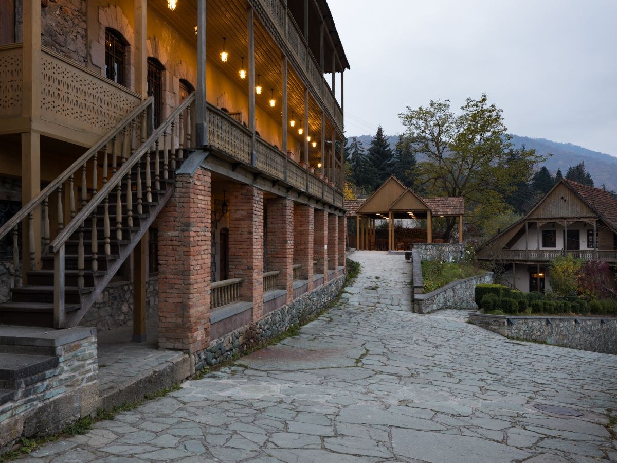 Stone-paved courtyard and wooden balconies at Tufenkian Old Dilijan Complex