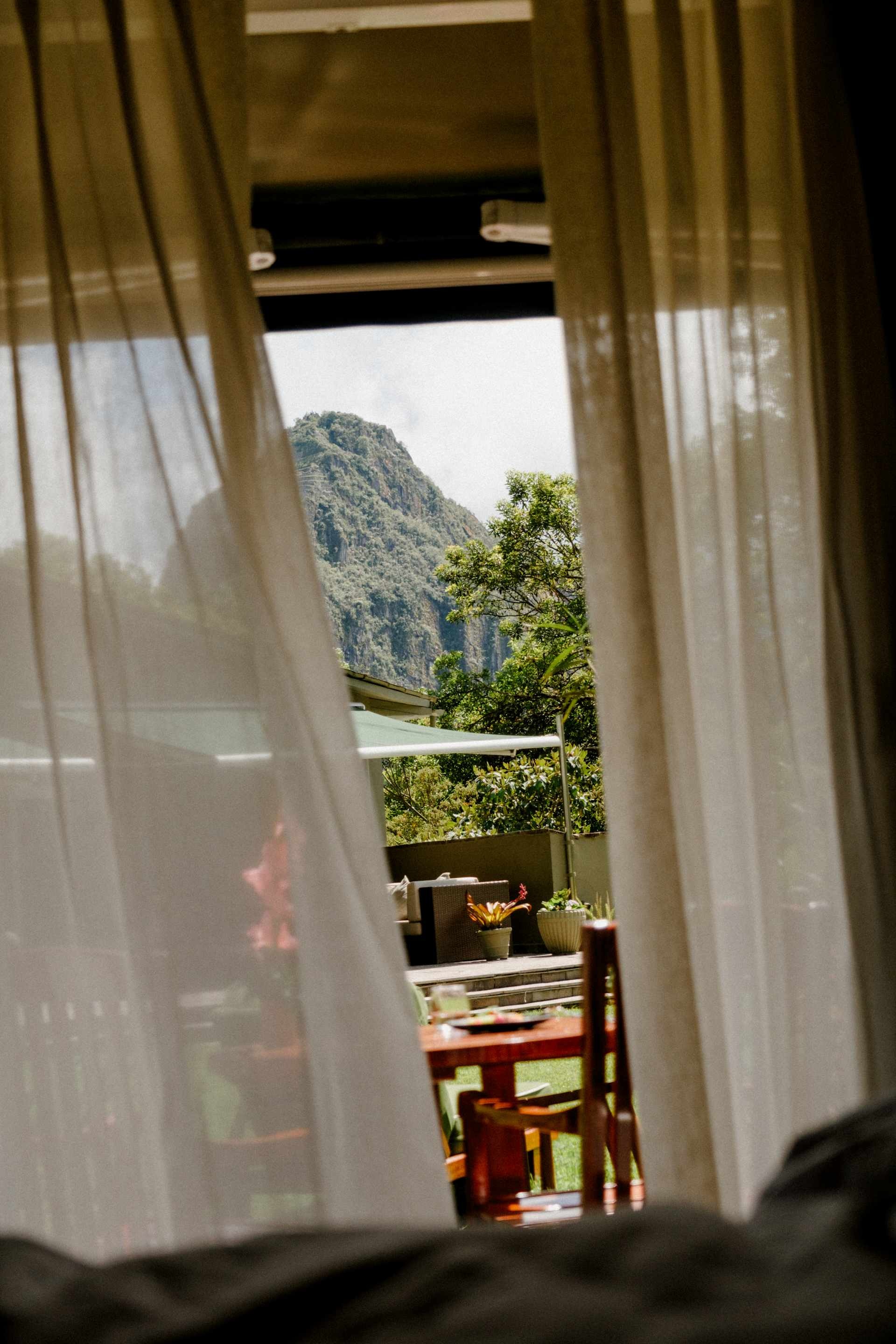Suite doorway framing the mountain beyond the gardens at Belmond Sanctuary Lodge, Machu Picchu, Peru