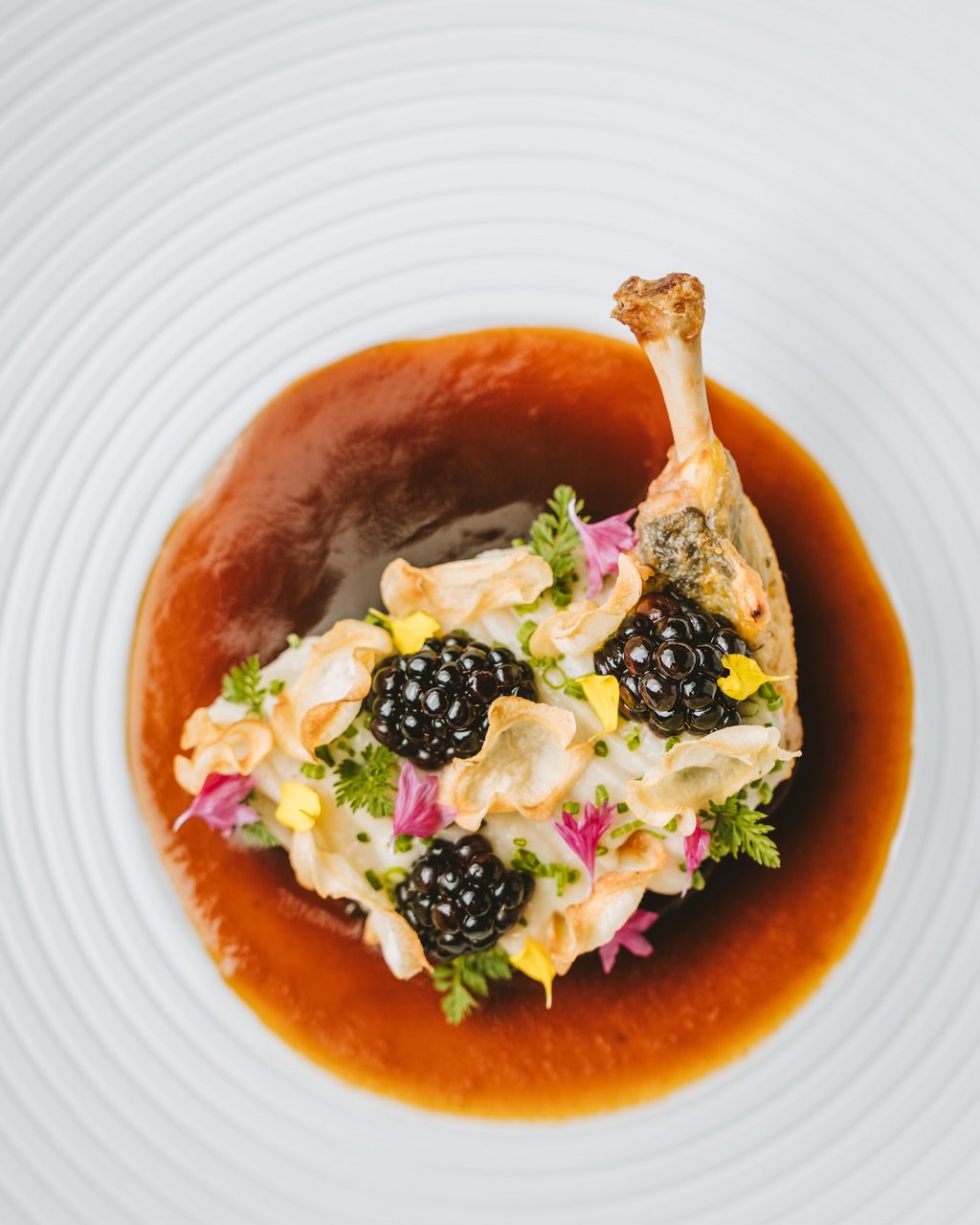 Plated poultry dish with sauce and garnishes at Post Lech Arlberg, Lech, Austria