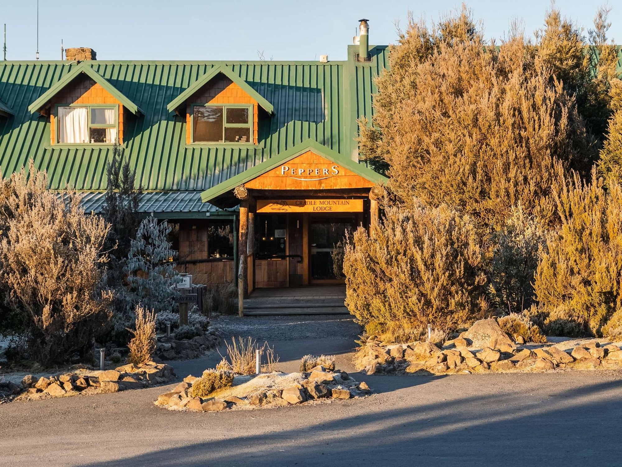 Timber lodge facade and autumn trees at Peppers Cradle Mountain Lodge