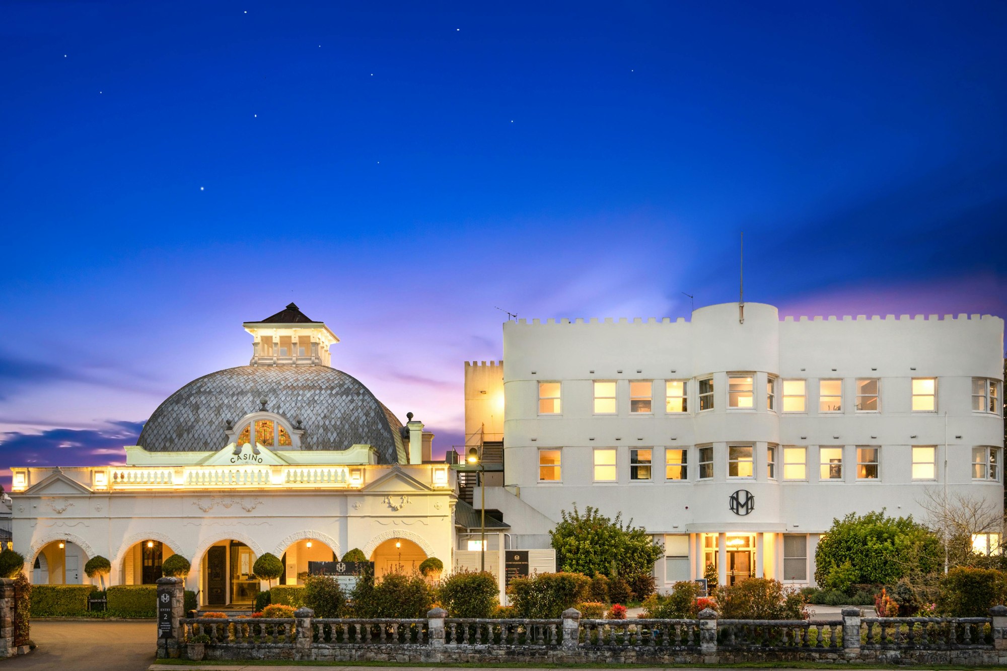 Illuminated Hydro Majestic Hotel dome and facade at dusk