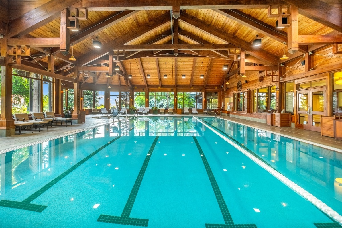 Indoor swimming pool beneath a timber-framed ceiling at Mohonk Mountain House, New Paltz, USA