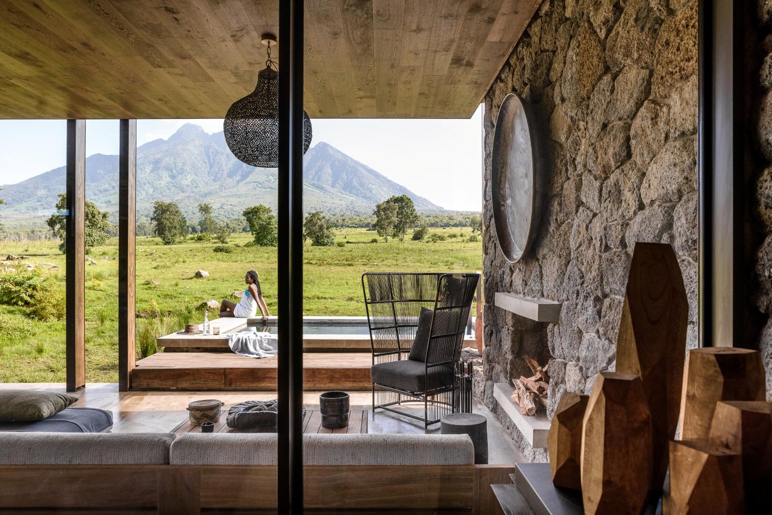 Sheltered lounge overlooking a plunge pool and volcanic peaks, Singita Kwitonda Lodge, Volcanoes National Park, Rwanda