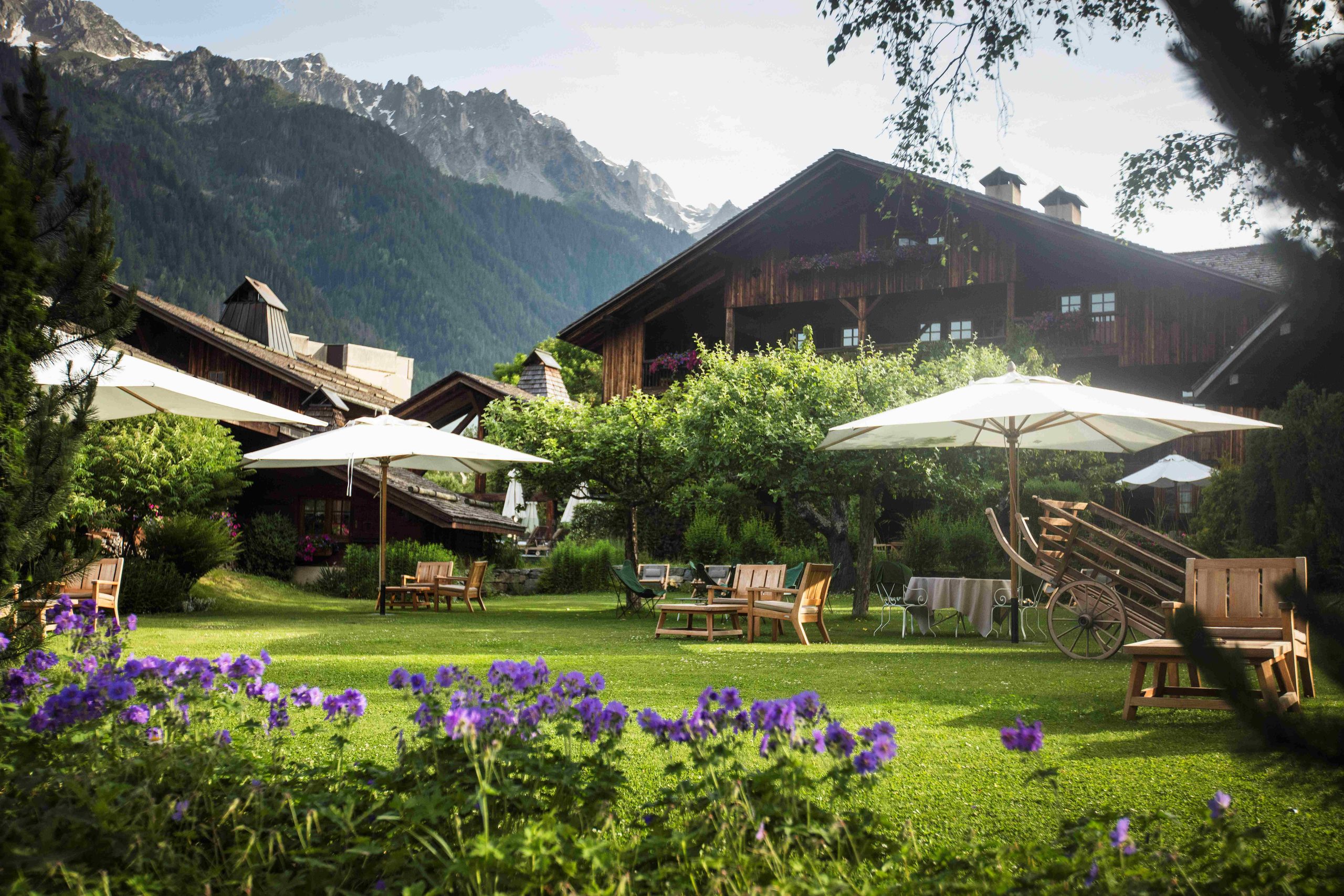 Flower-filled summer garden in front of La Ferme chalet, Le Hameau Albert 1er, Chamonix, France