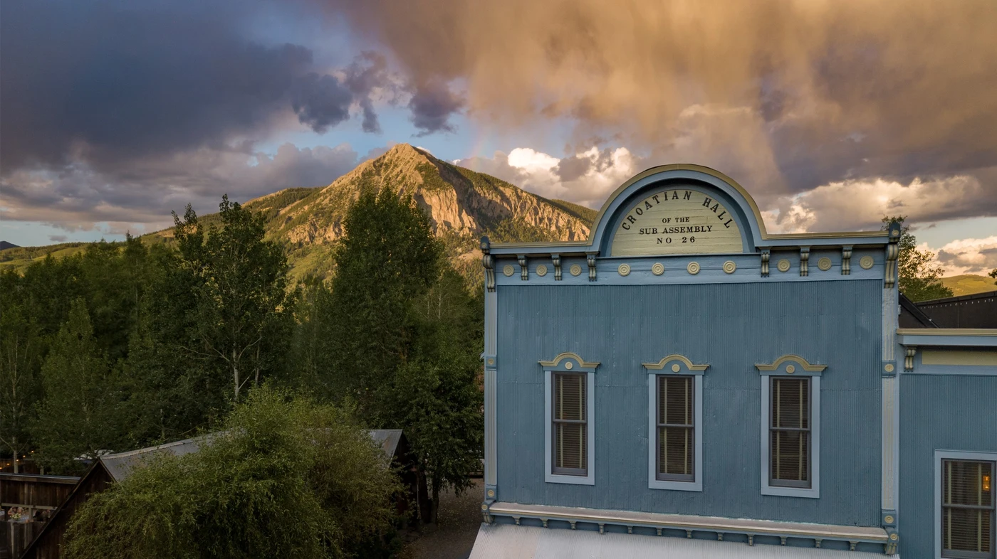 Eleven Scarp Ridge Lodge historic façade against the surrounding mountains, Crested Butte, USA