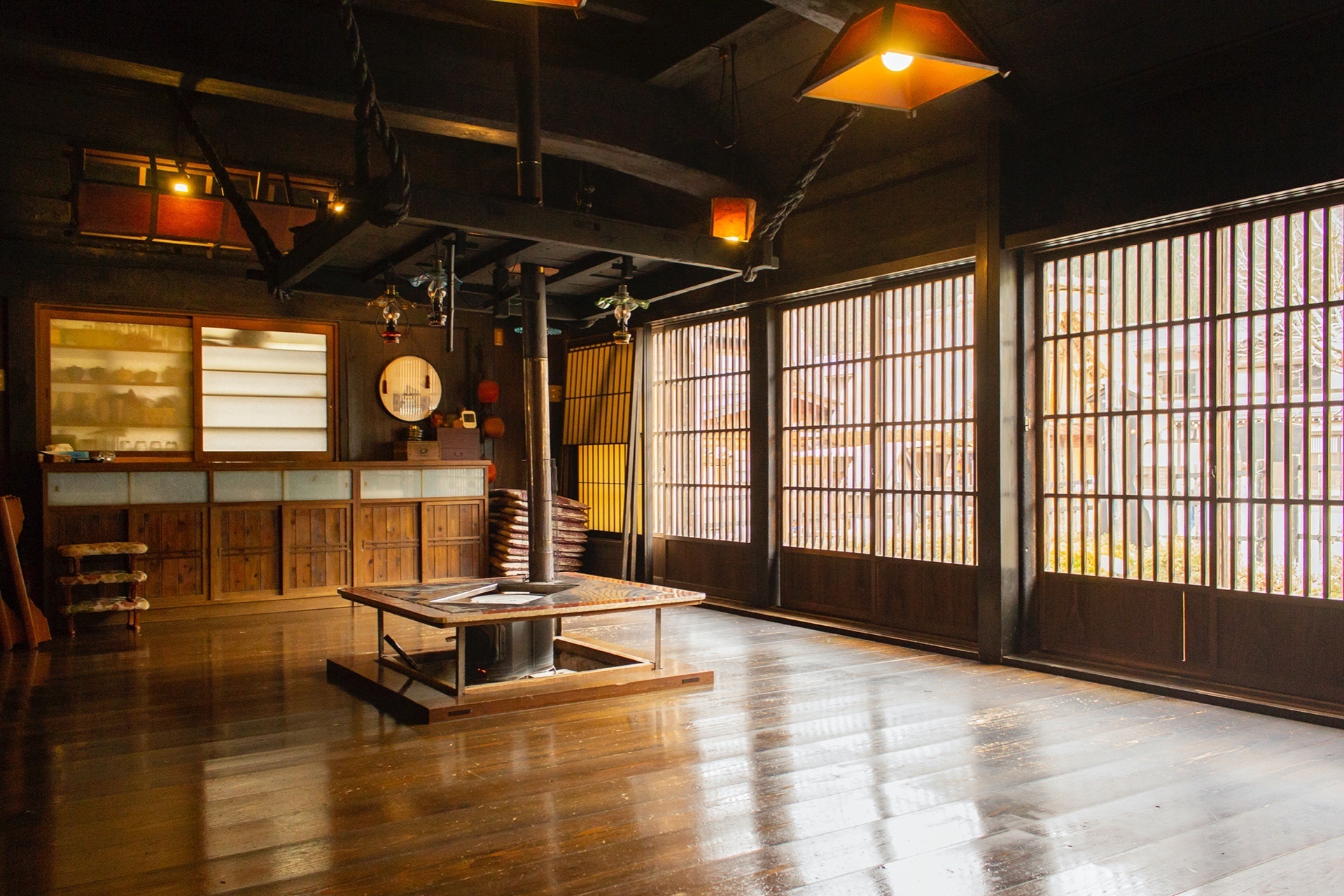 Wooden gathering room with a central hearth at Koemon, Shirakawa-go, Japan