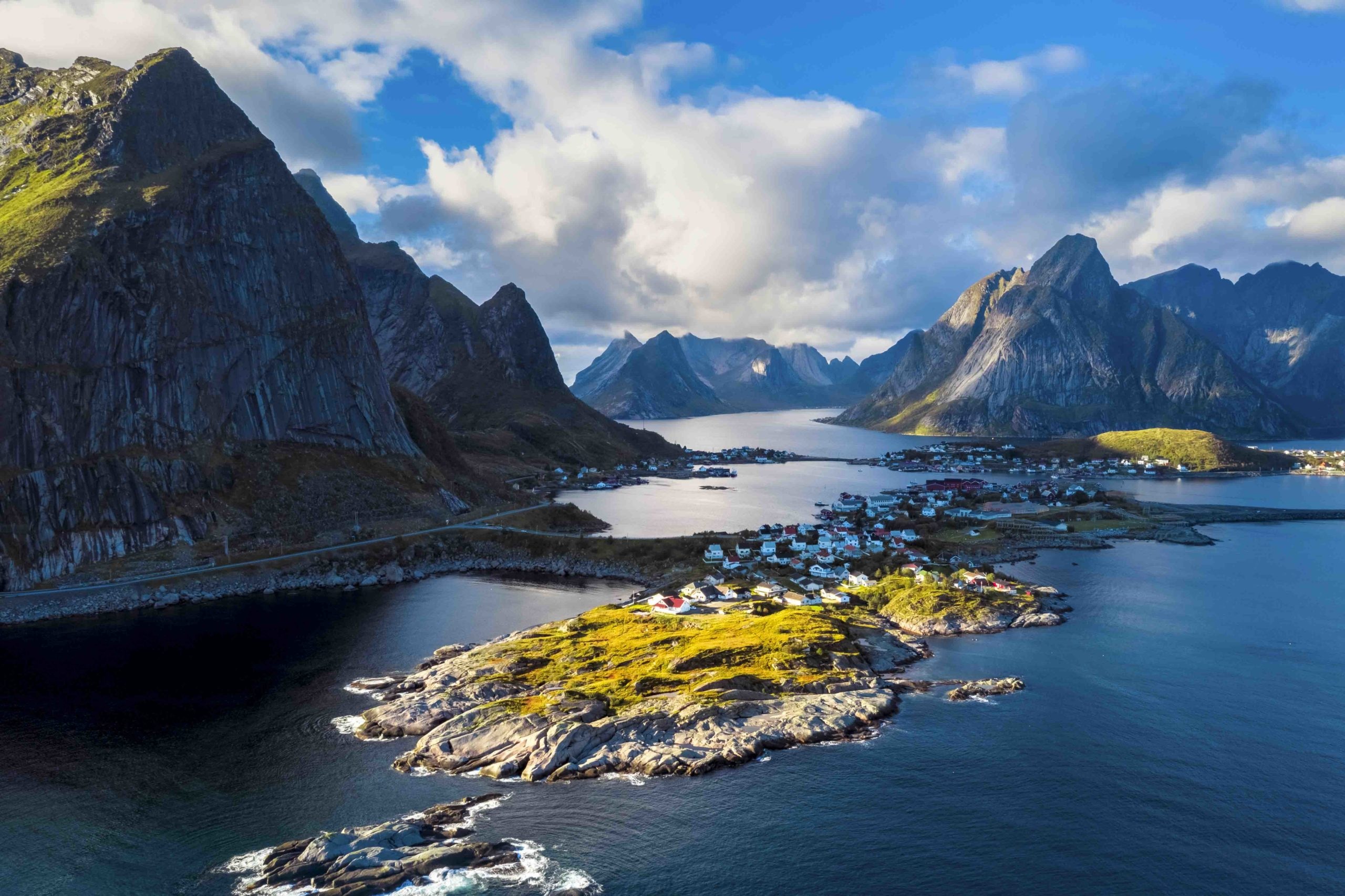 Aerial landscape of Reine, fjords, and dramatic mountain peaks