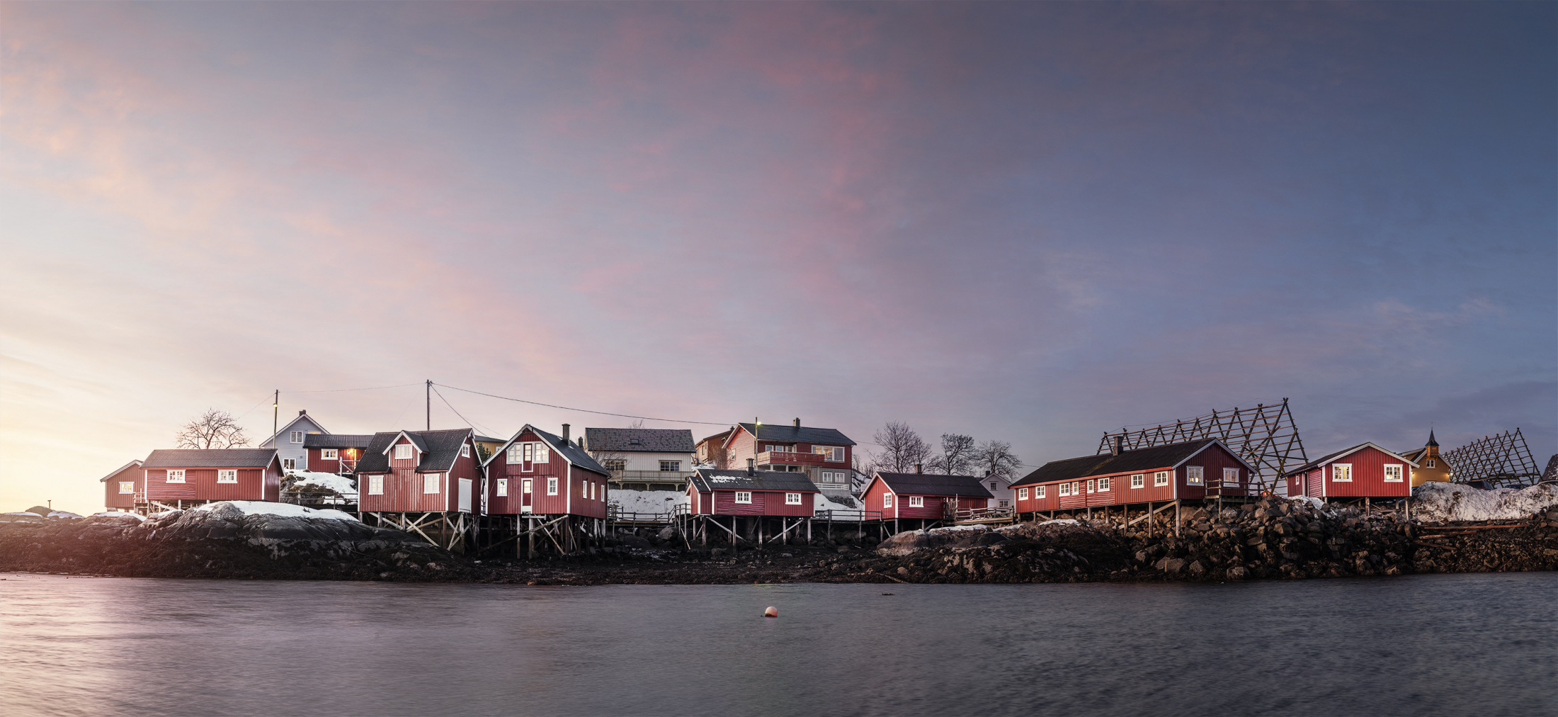 Elevated panoramic view across Svinøya and its waterfront cabins, Lofoten, Norway