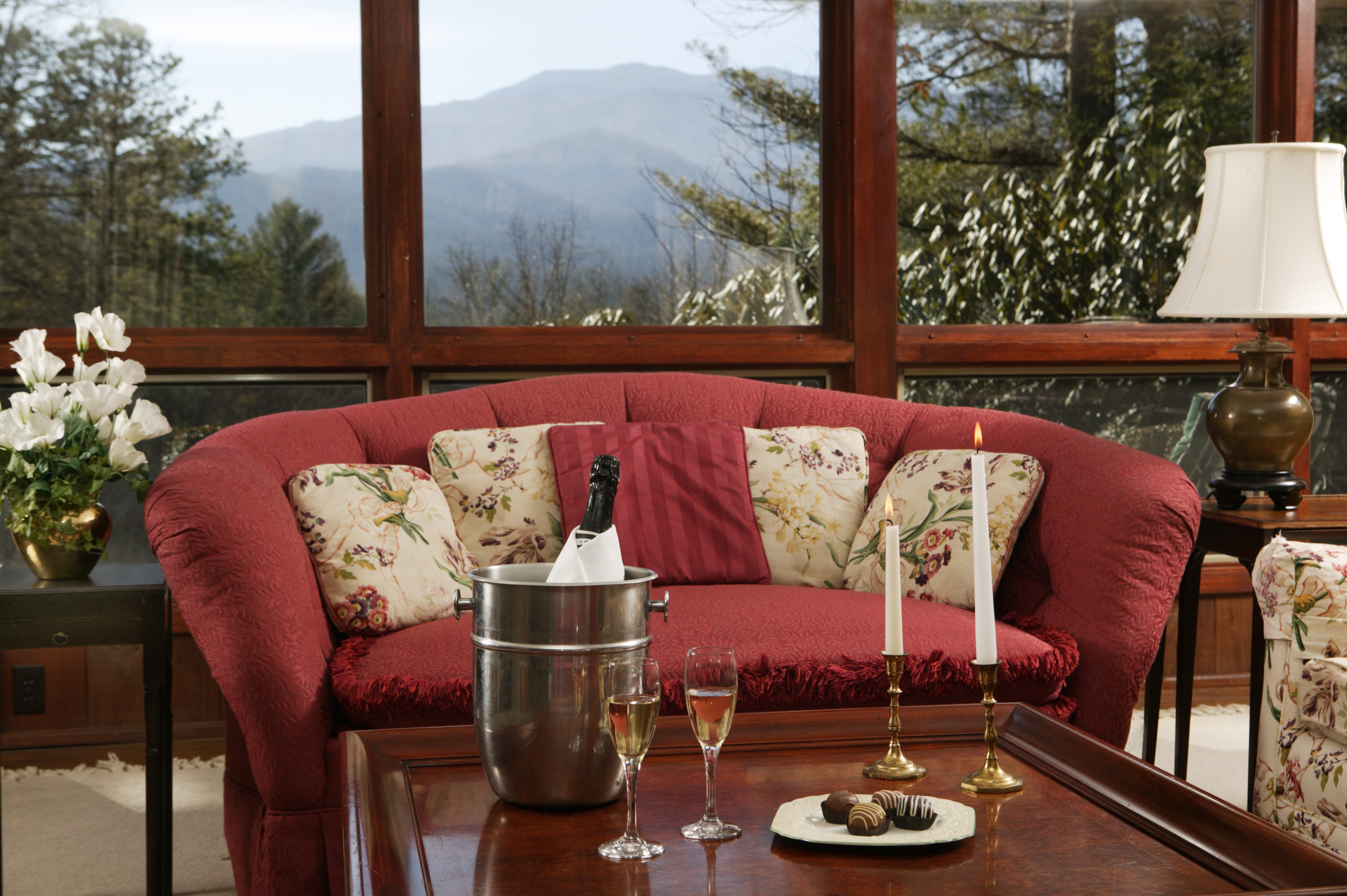Sitting area with mountain views through large windows at Buckhorn Inn, Gatlinburg, USA