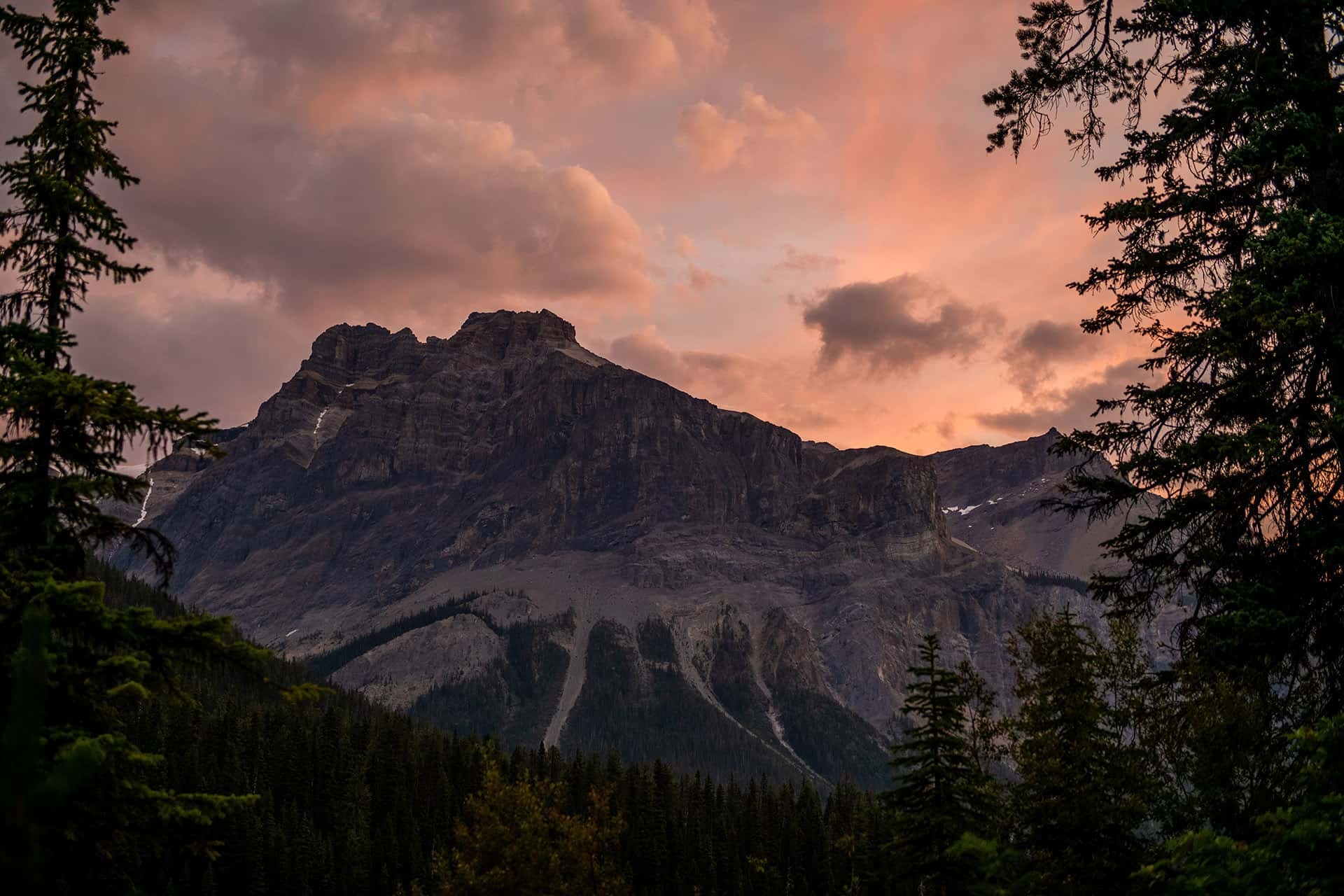 Mountain skyline beneath a colorful evening sky at Emerald Lake Lodge, Yoho National Park, Canada