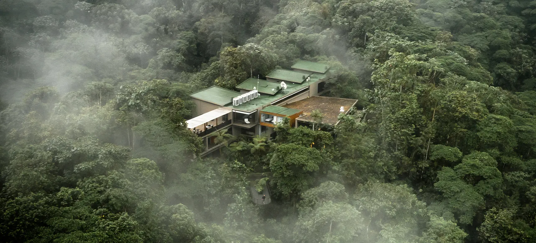 Aerial view of Mashpi Lodge surrounded by misty forest, Ecuador