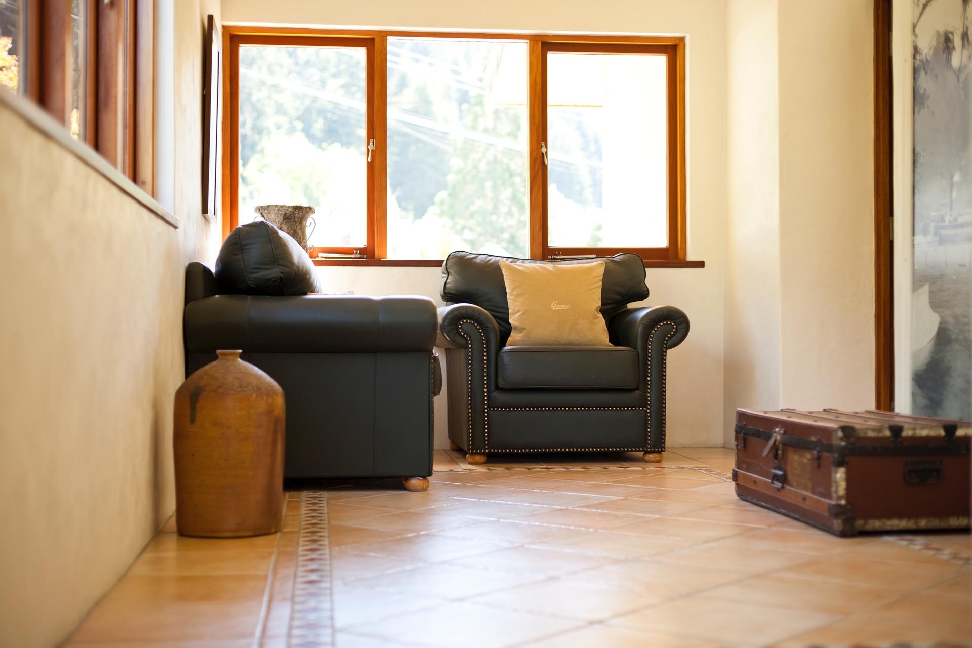 Lounge seating beside a sunny window at Browns Boutique Hotel, Queenstown, New Zealand