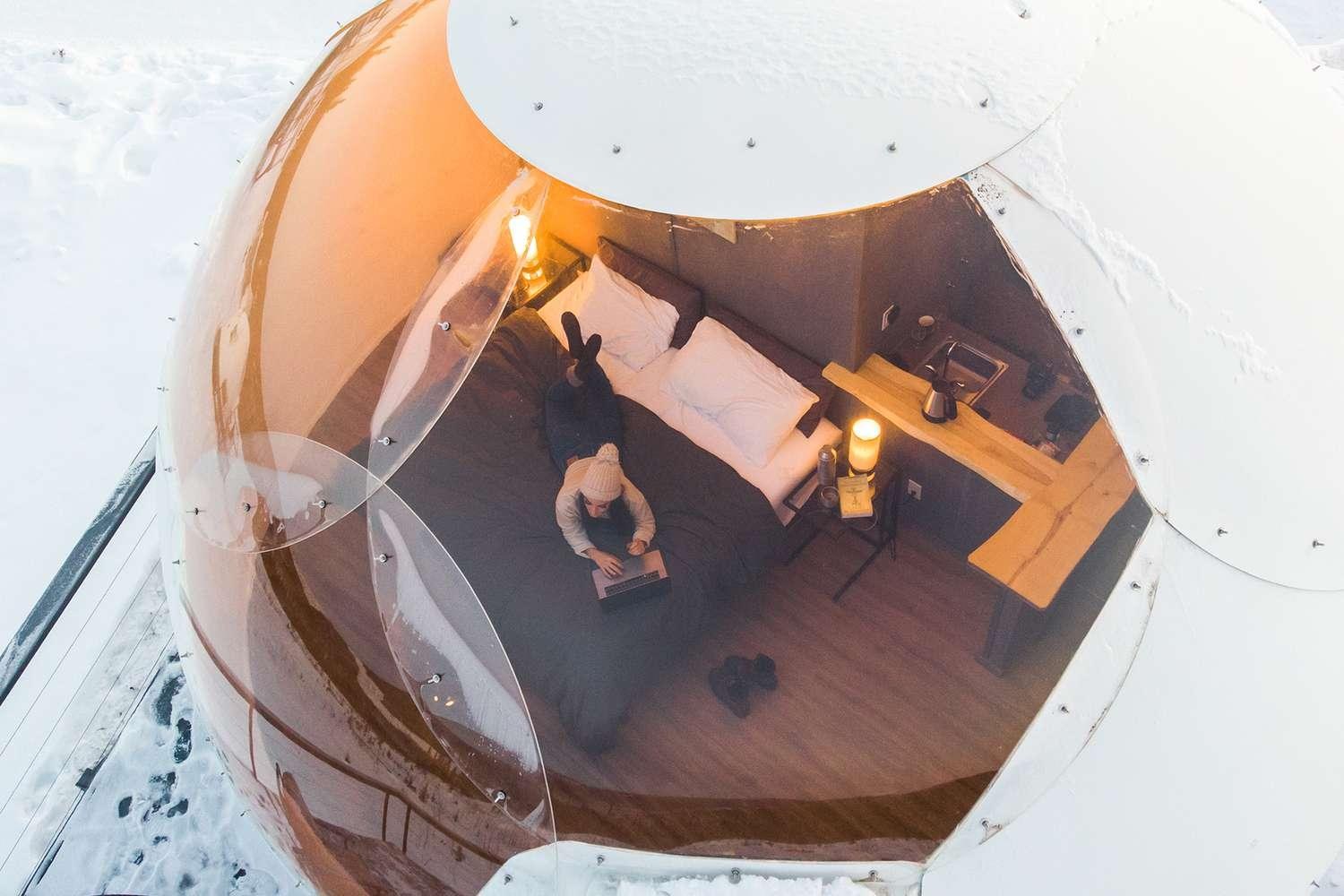 Overhead view into an igloo through its curved ceiling window, Borealis Basecamp, Alaska, USA