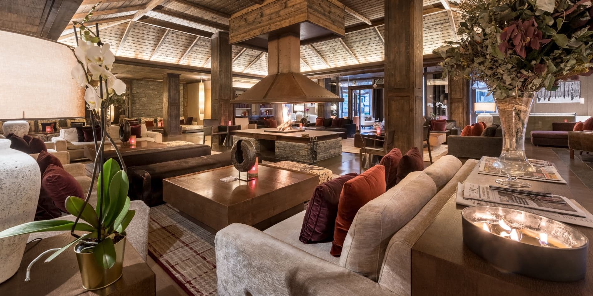 Hotel lounge with sofas and timber roof beams at Hotel Val de Neu, Baqueira-Beret, Spain