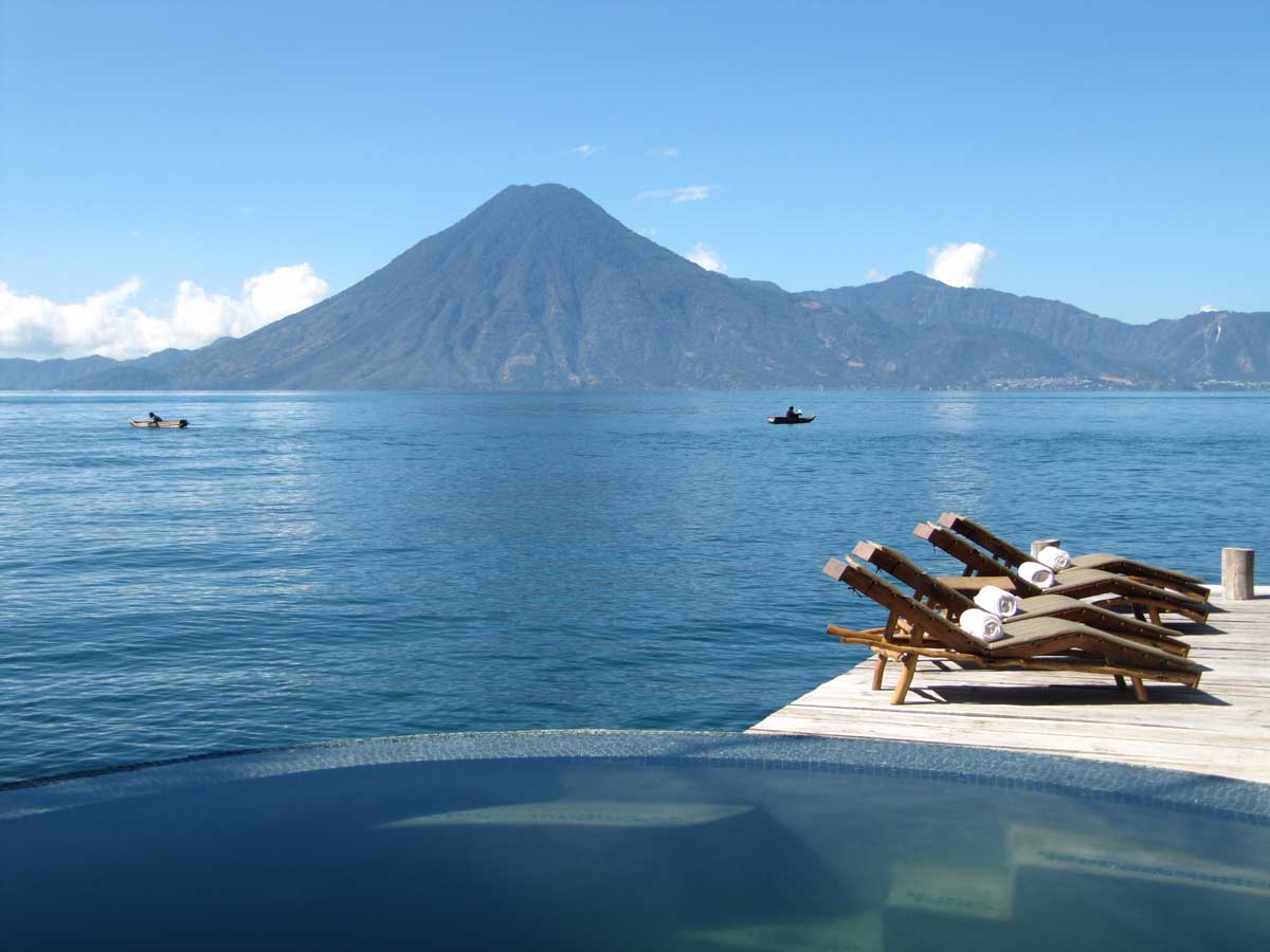 Lakeside pool and reclining chairs with volcano views, Laguna Lodge, Lake Atitlán, Guatemala