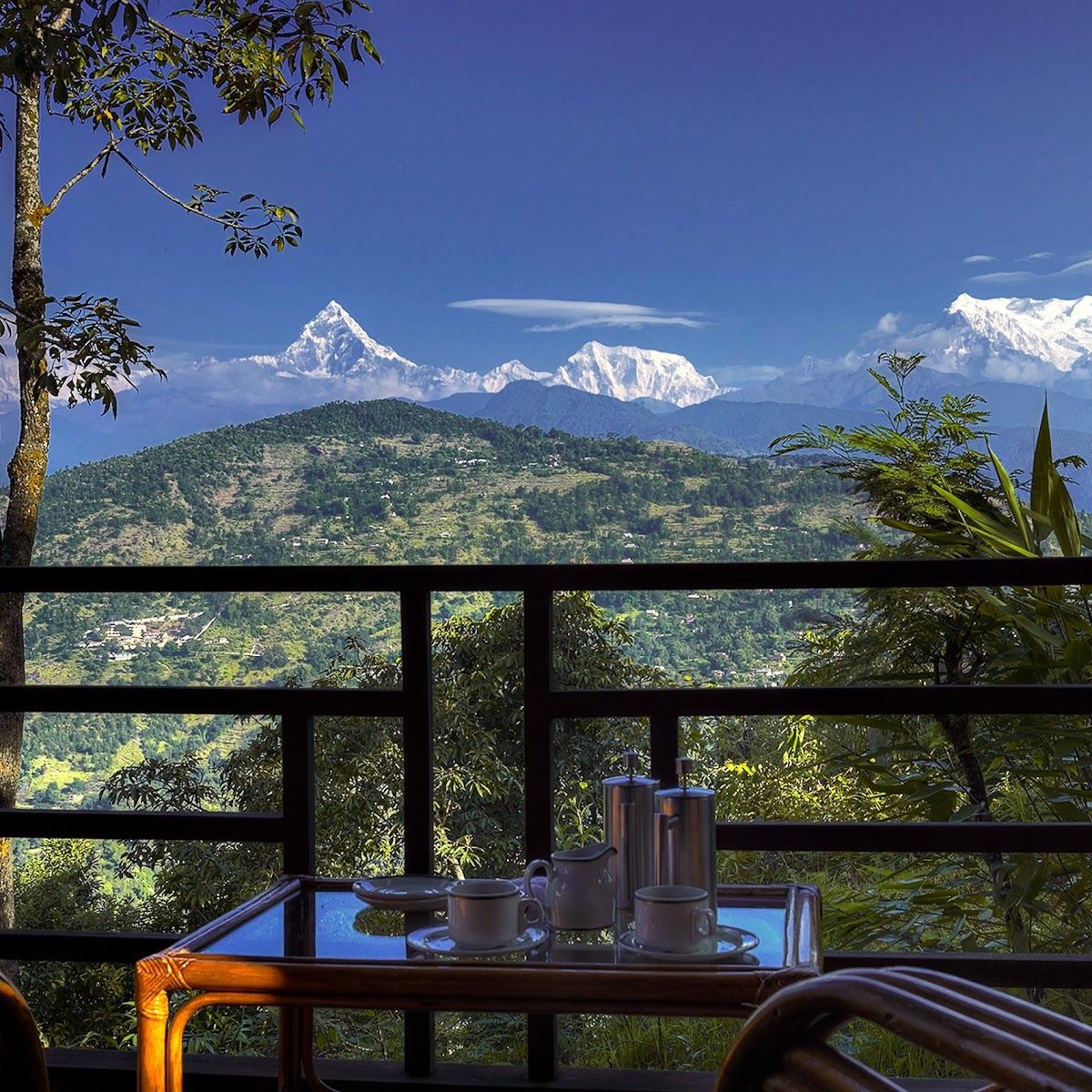Outdoor dining table with mountain views at Tiger Mountain Pokhara Lodge, Nepal