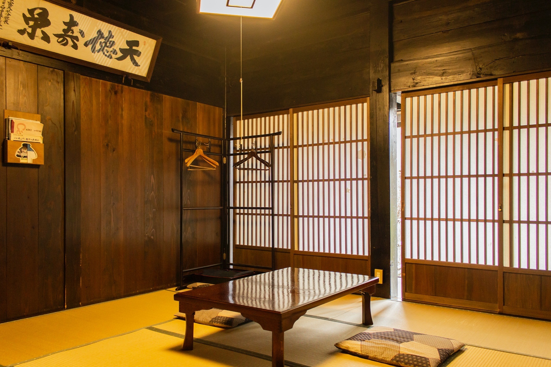 Traditional wooden interior with shoji screens and a low table at Koemon, Shirakawa-go, Japan