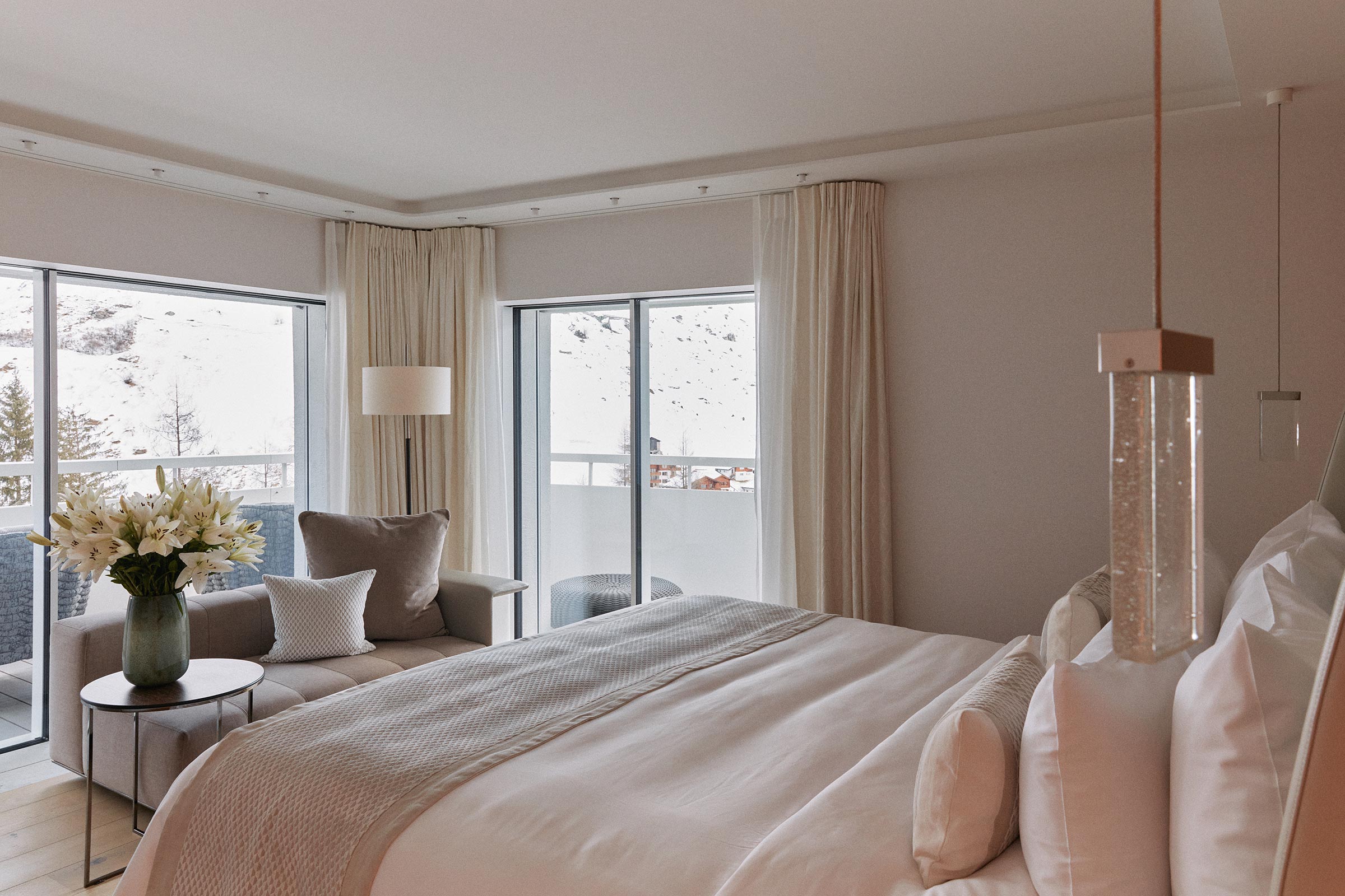 Light-coloured double bedroom with large windows at 7132 Hotel, Vals, Switzerland