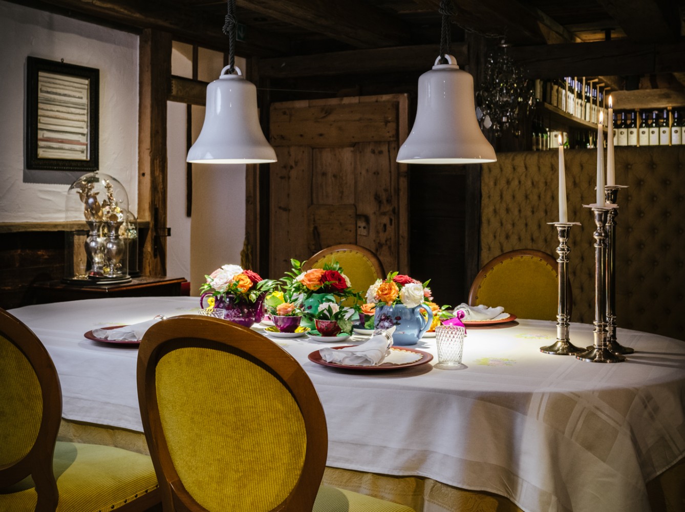 Set dining table in a traditional dark-wood dining room at Hotel La Perla, Corvara, Italy