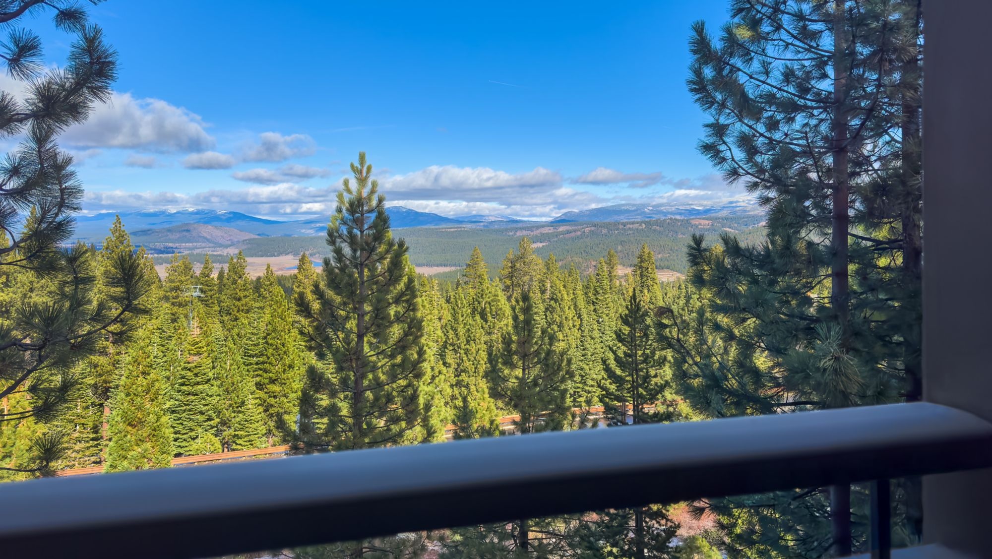 Forest and distant mountain views from a balcony at The Ritz-Carlton, Lake Tahoe, Northstar, USA