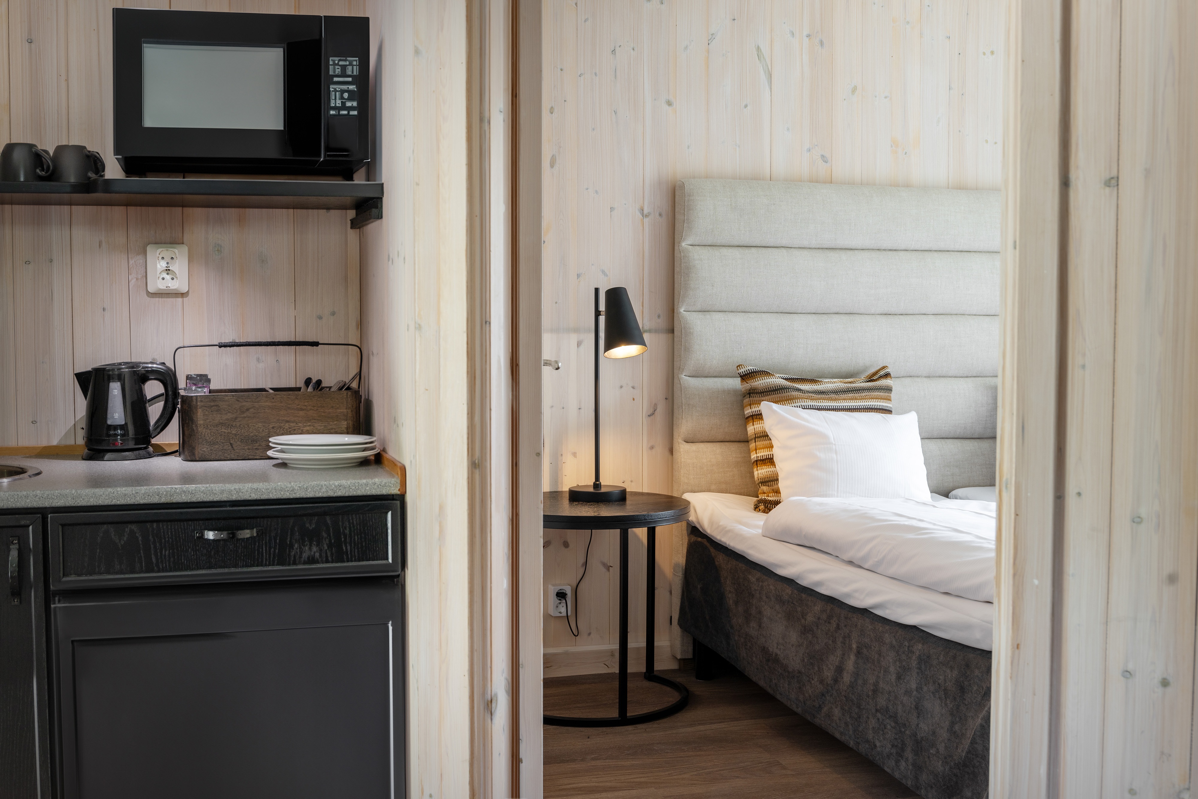 Arctic cabin bedroom and kitchenette at Icehotel, Jukkasjärvi, Swedish Lapland