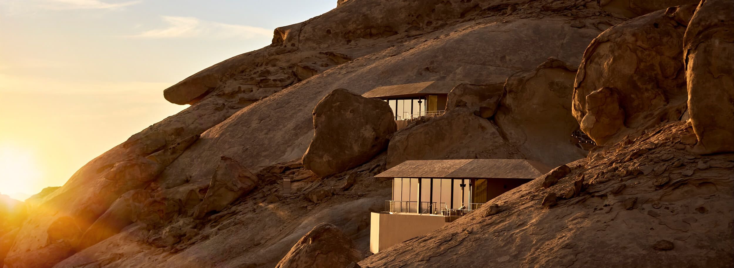 The Cliff Hanging Villas of Desert Rock perched on the granite rock face at sunset