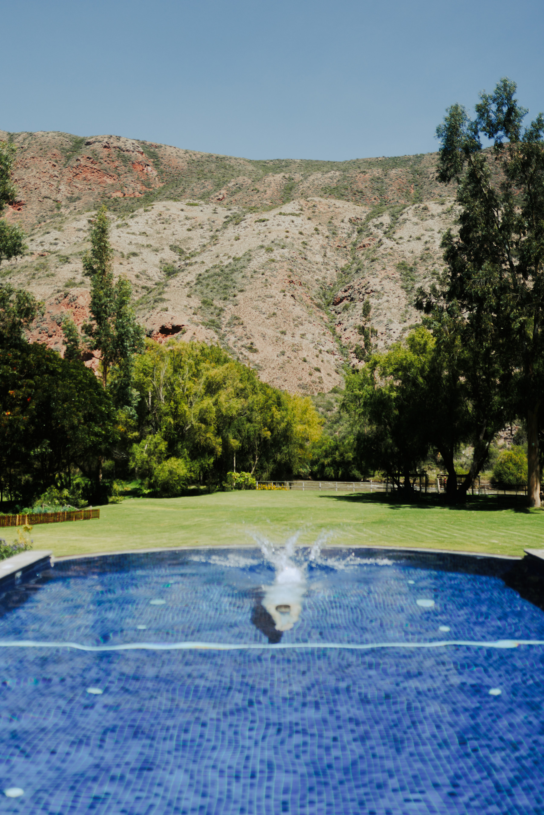 Heated outdoor pool beneath the valley's mountains at Belmond Hotel Rio Sagrado, Sacred Valley, Peru