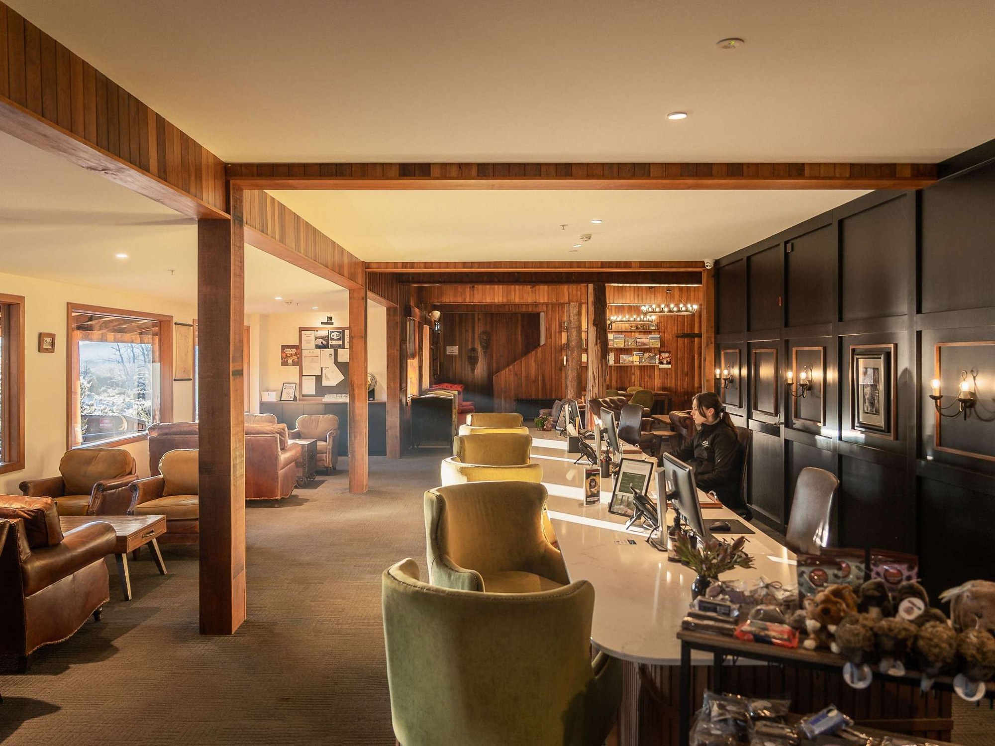 Lounge seating and stone fireplace at Peppers Cradle Mountain Lodge