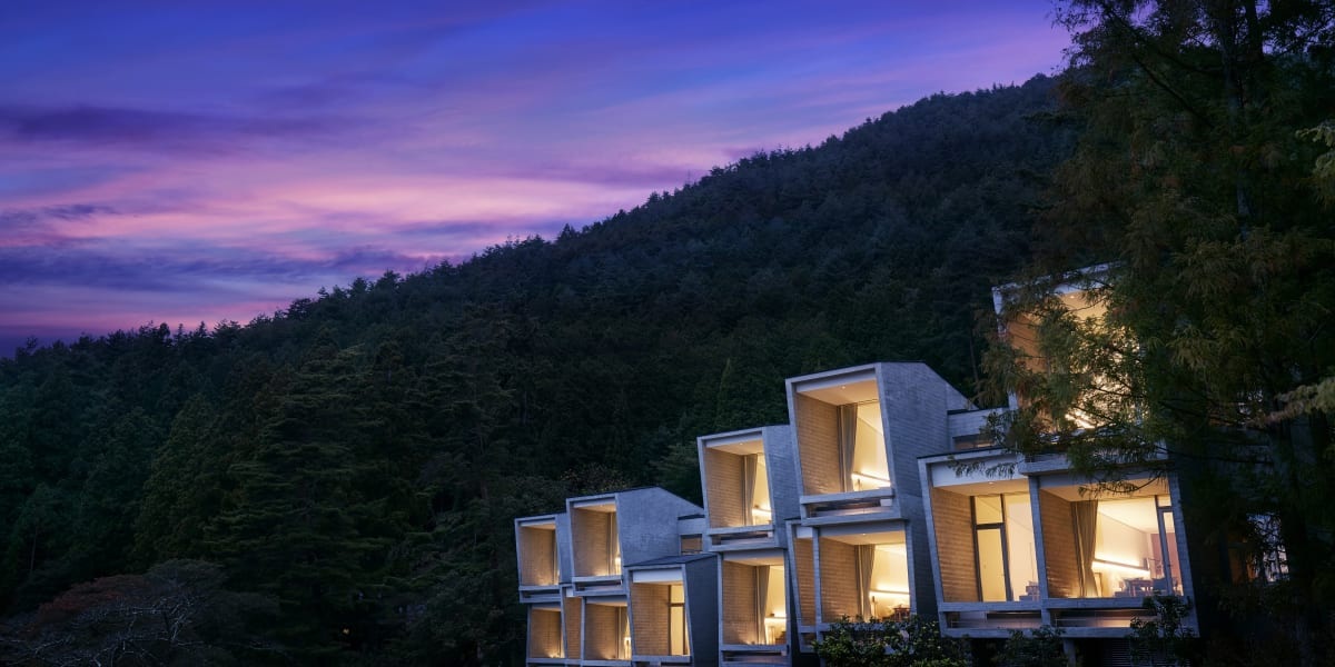 Illuminated cabins at twilight at Hoshinoya Fuji, Lake Kawaguchi, Japan