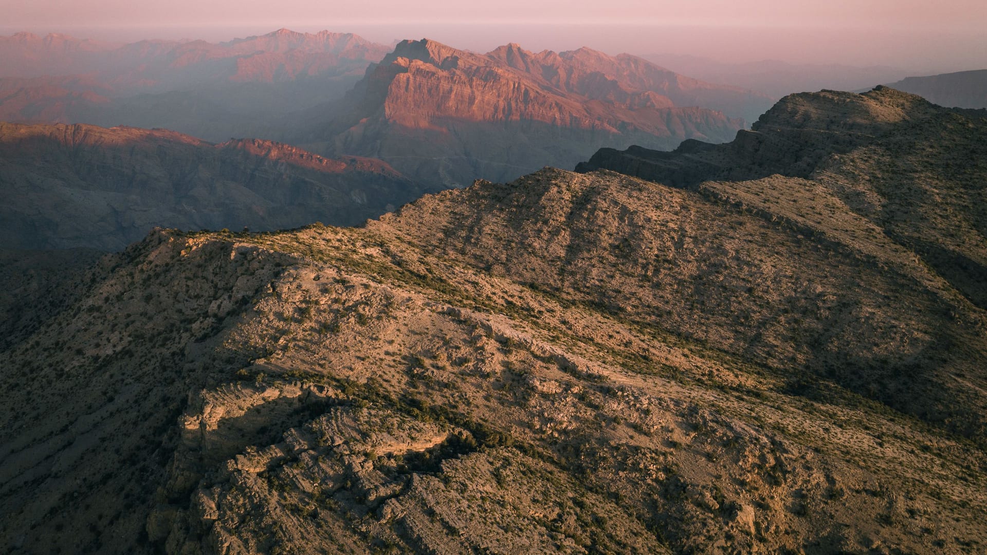 Rugged mountain ridges and deep canyons in warm evening light, Alila Jabal Akhdar, Jebel Akhdar, Oman