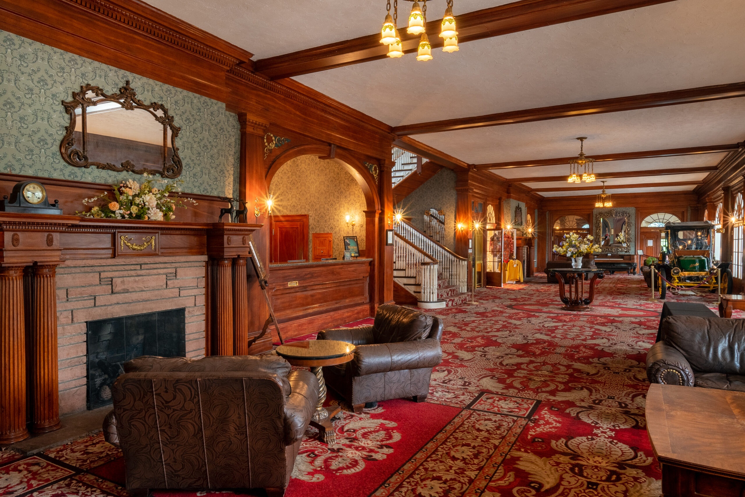 Historic lobby with fireplace and patterned carpet at The Stanley Hotel, Estes Park, USA