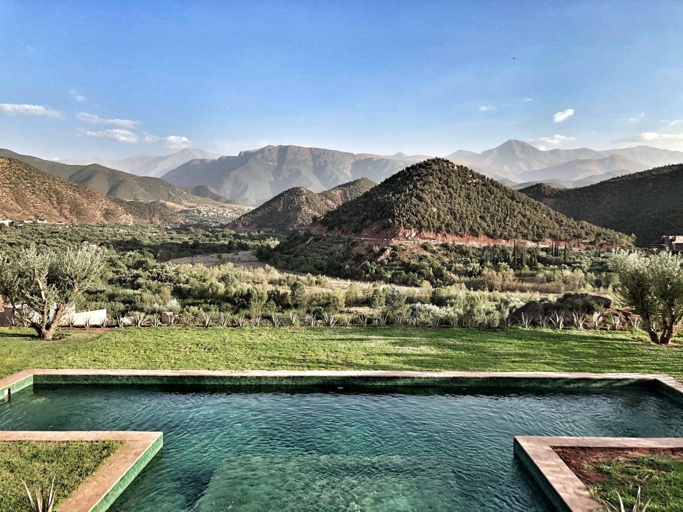 Outdoor swimming pool overlooking the valley and hills at Kasbah Bab Ourika, Ourika Valley, Morocco