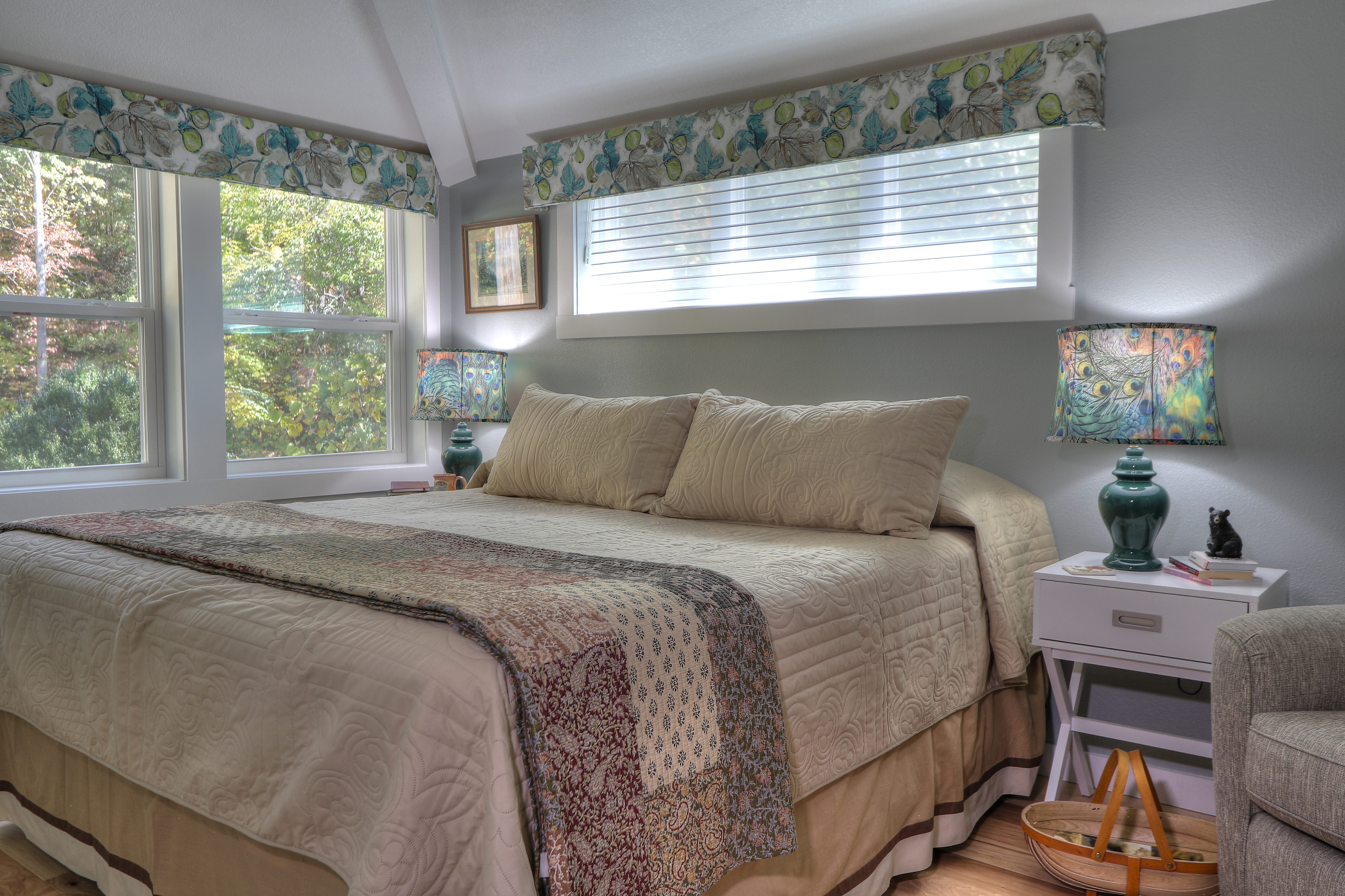 Guest bedroom with windows overlooking trees at Buckhorn Inn, Gatlinburg, USA