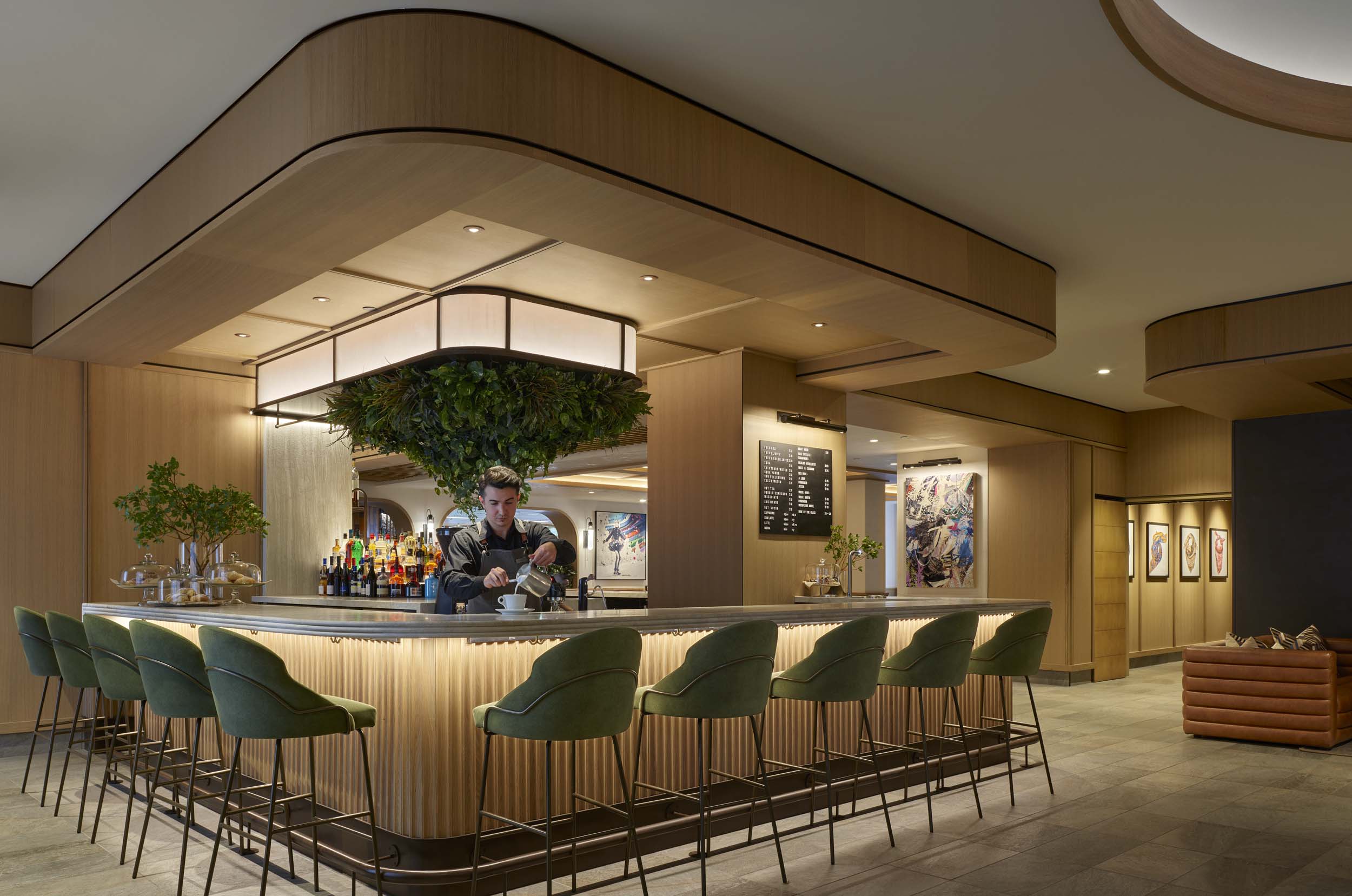 Curved counter and green bar stools at Café V in Viceroy Snowmass.