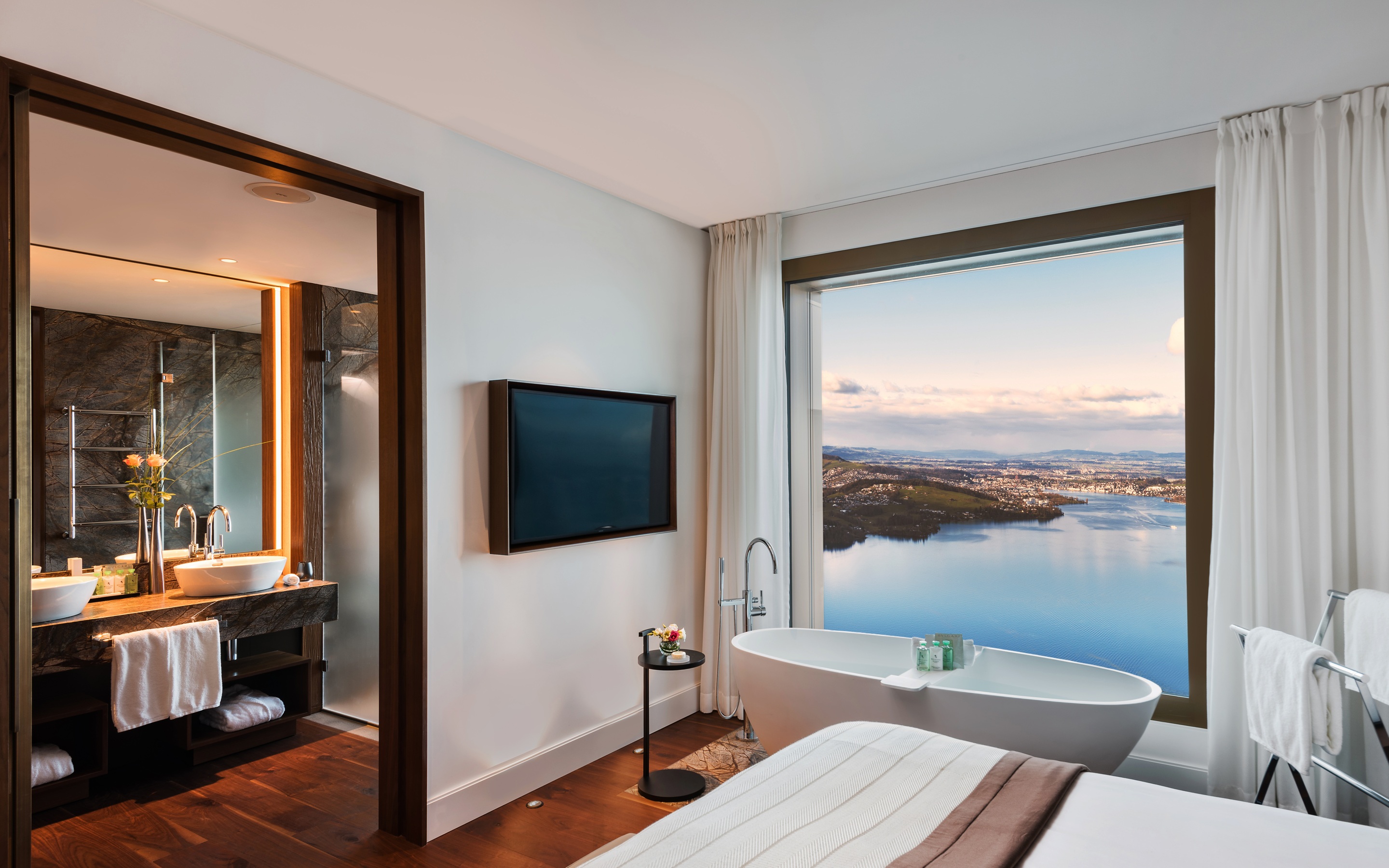 Suite bathroom with freestanding tub and lake view at Bürgenstock Resort, Lake Lucerne, Switzerland