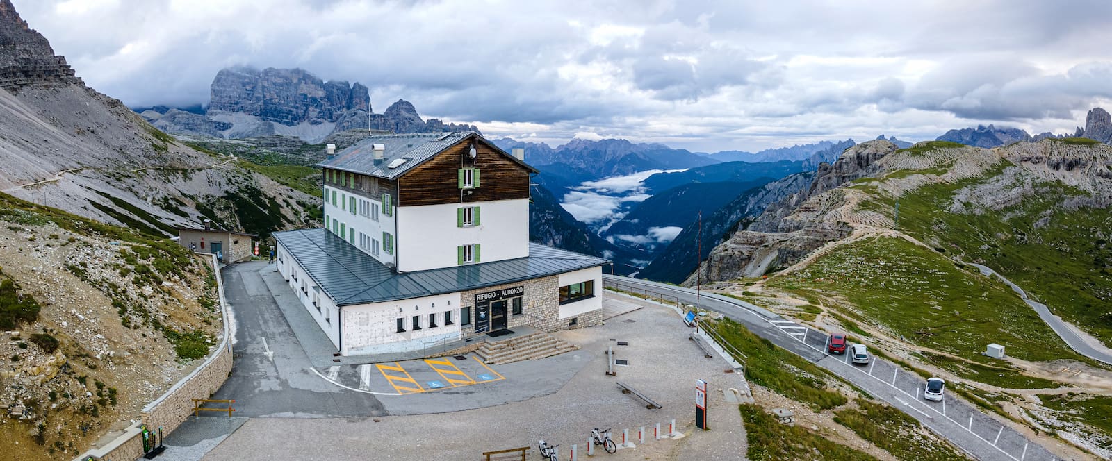 Elevated view of the refuge, terrace and surrounding mountain landscape at Rifugio Auronzo, Tre Cime di Lavaredo, Italy