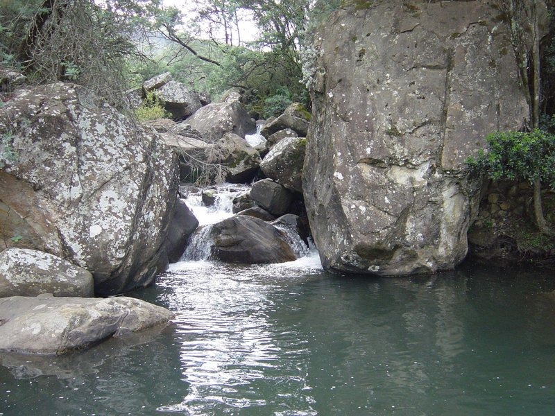 Natural swimming pool beneath a small rocky waterfall, Cleopatra Mountain Farmhouse, Drakensberg, KwaZulu-Natal, South Africa