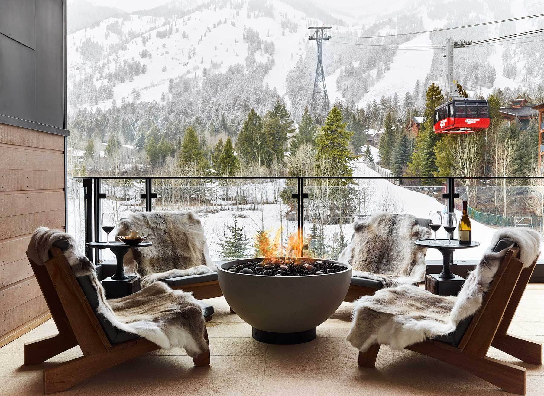 Snowy mountain-view terrace with fire pit, Caldera House, Teton Village, USA