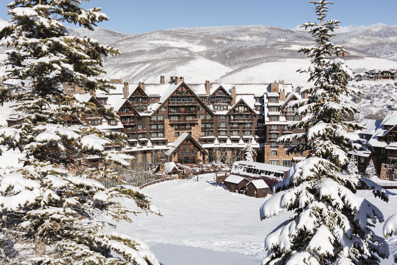 Snow-covered timber-and-stone lodge at The Ritz-Carlton, Bachelor Gulch, beneath the Beaver Creek ski slopes.