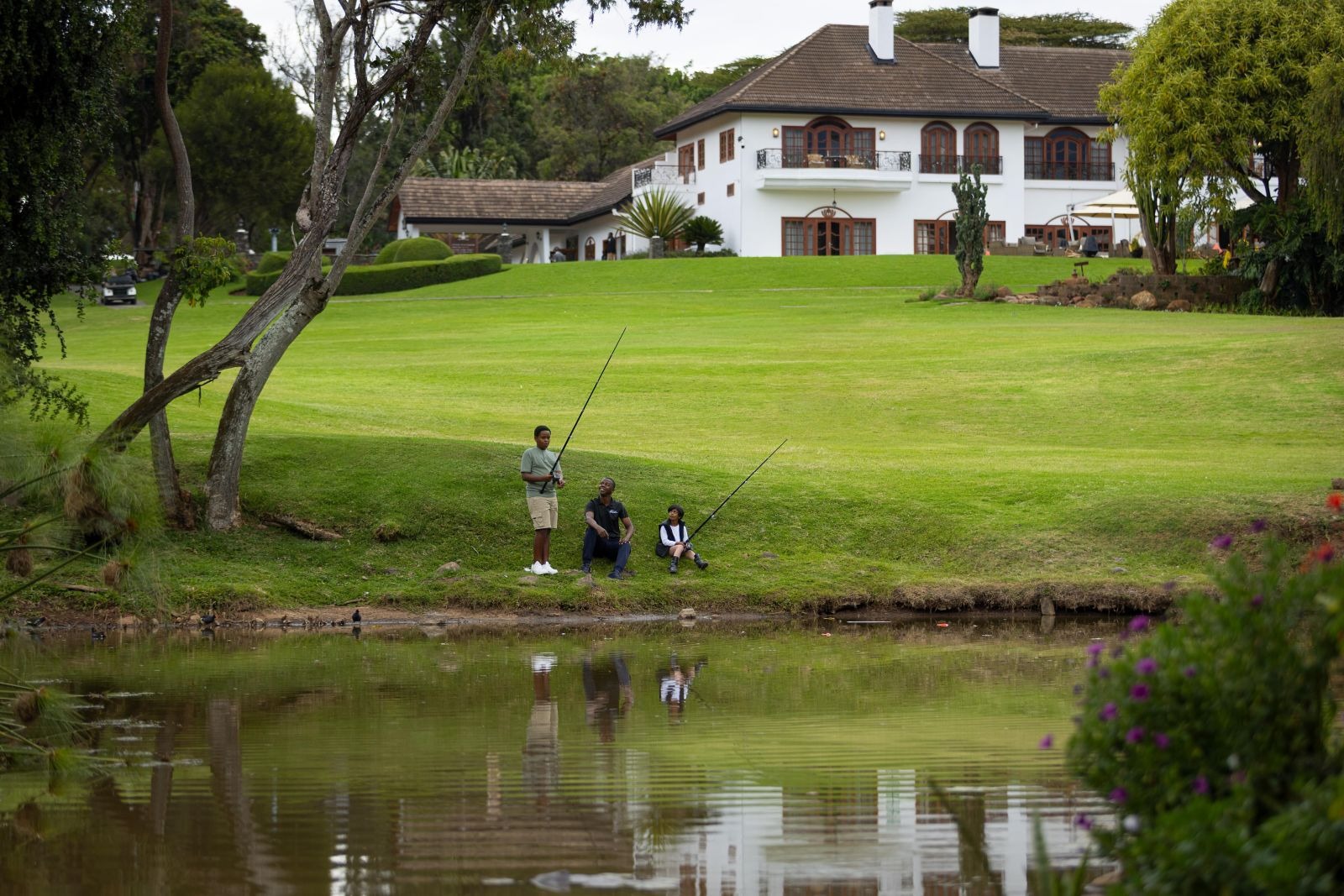 Hotel exterior beside a pond and manicured lawns, Fairmont Mount Kenya Safari Club, Nanyuki, Kenya