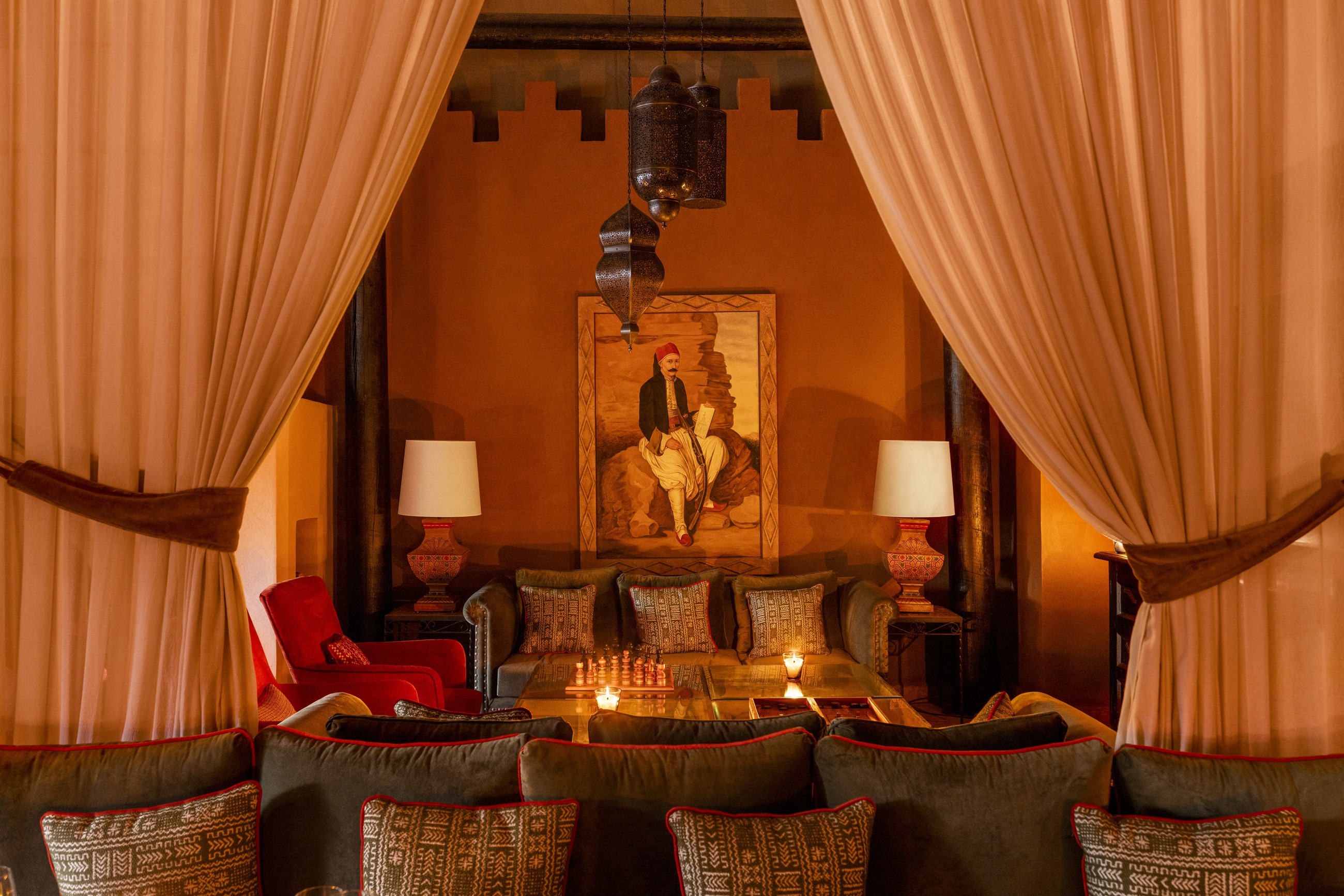 Asayss restaurant with Moroccan furnishings and evening candlelight at Kasbah Tamadot, Atlas Mountains, Morocco