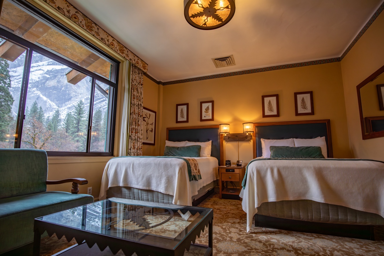 Guest room with two beds and a mountain-facing window at The Ahwahnee, Yosemite National Park, USA