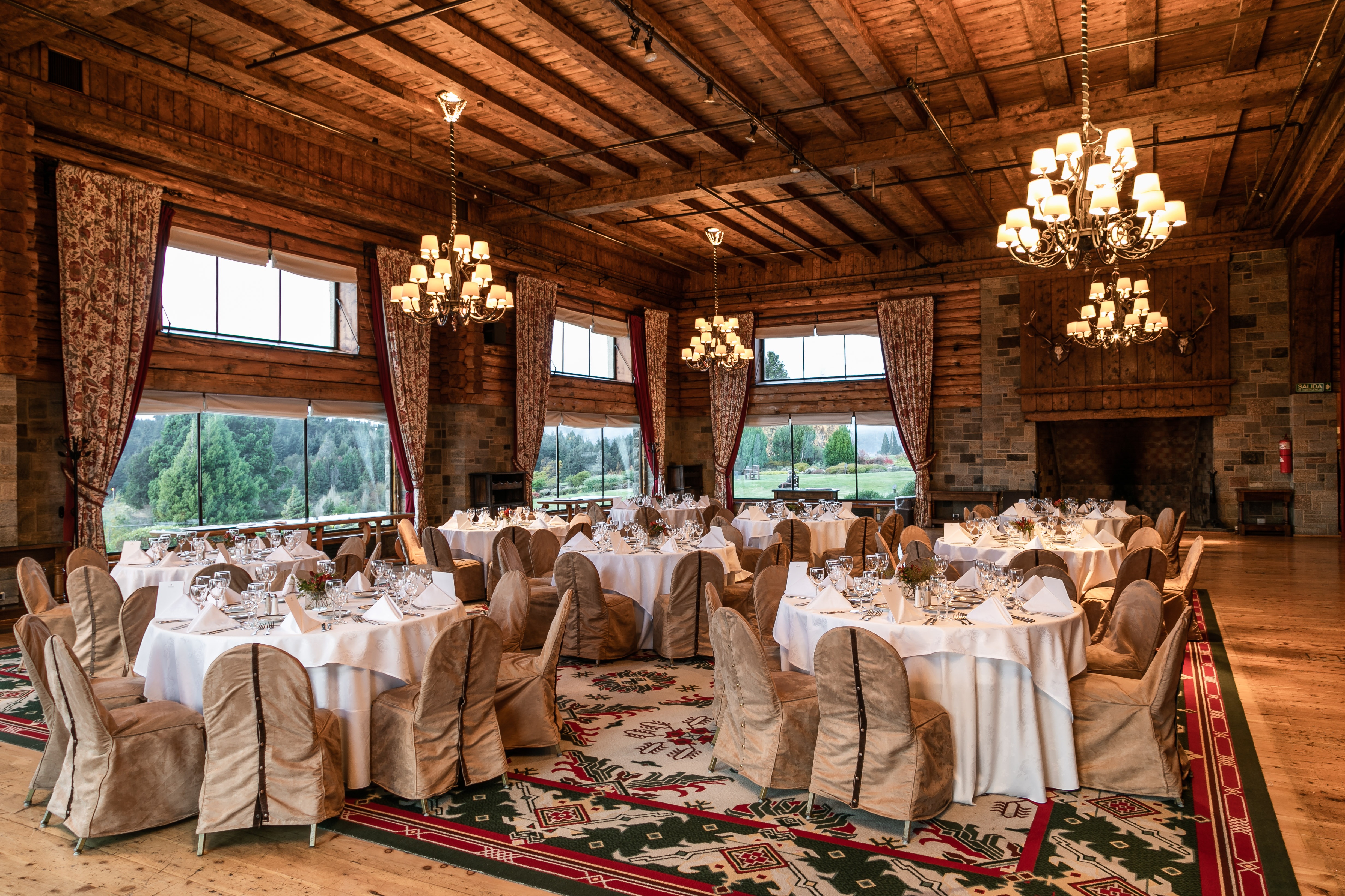 Timber-ceilinged dining room set for an event at Llao Llao Hotel & Resort, Bariloche, Argentina