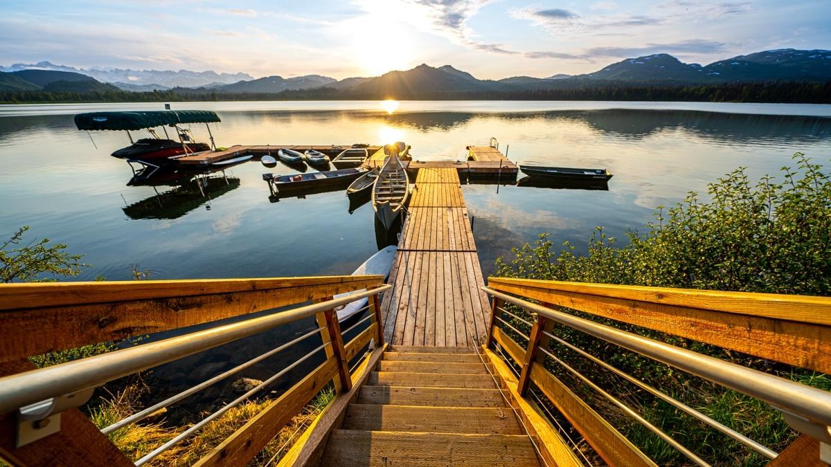 Lakeside lodge deck overlooking Judd Lake and mountains, Tordrillo Mountain Lodge, Alaska, USA