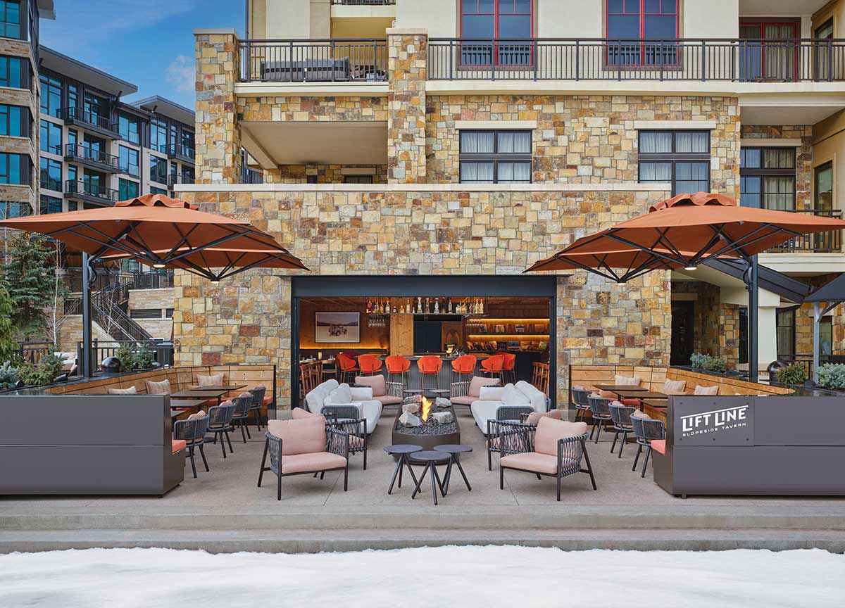 Snow-lined Lift Line Tavern terrace with outdoor seating at Viceroy Snowmass.